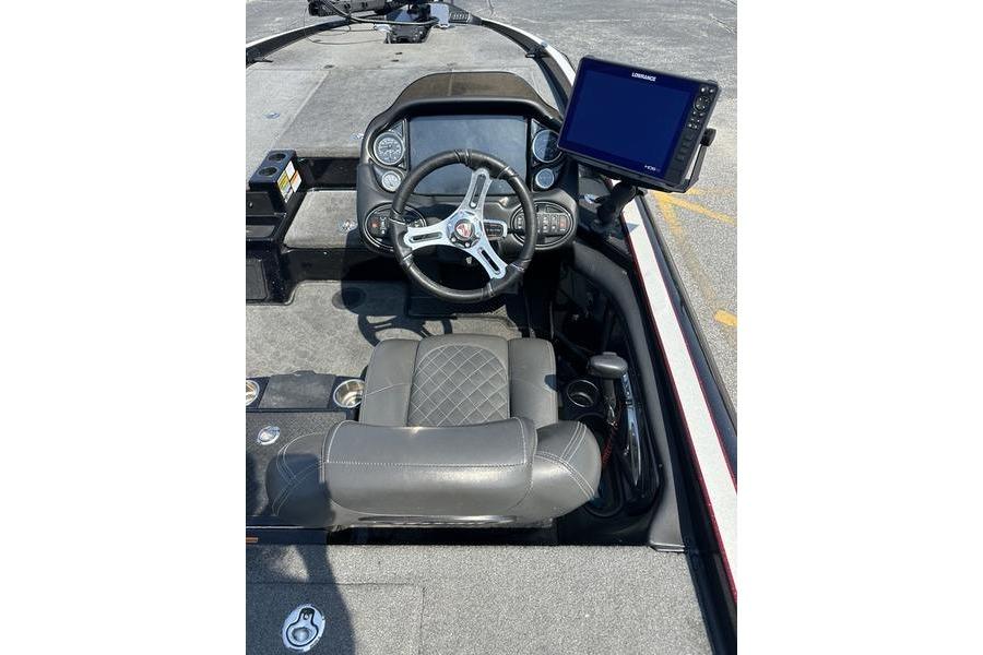 2016 Triton 20 TrX boat cockpit with steering wheel and navigation display.