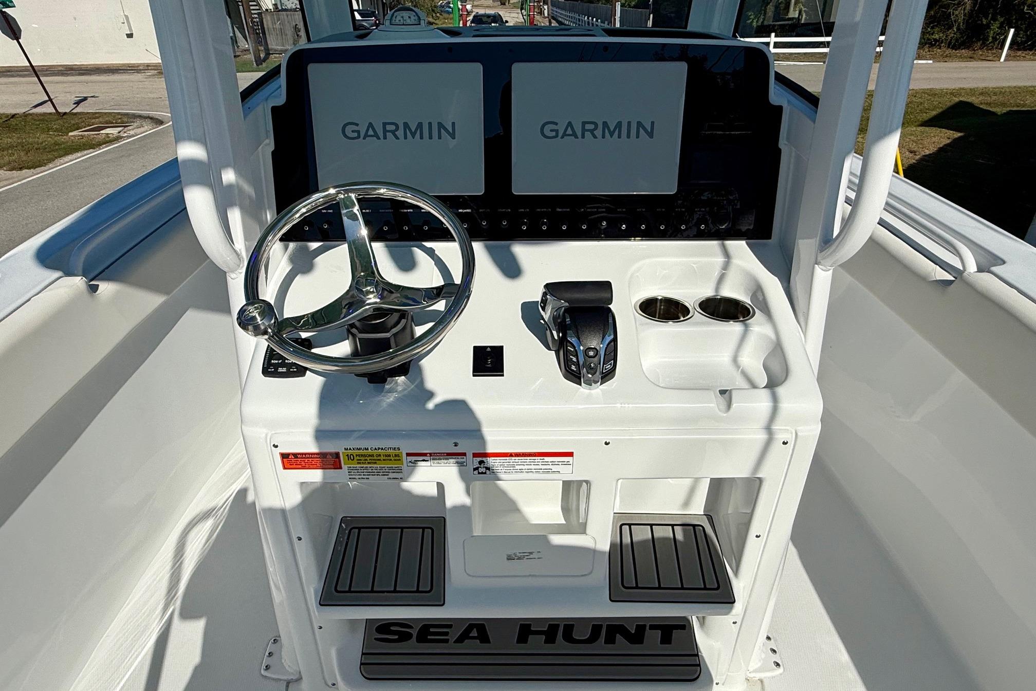2026 Sea Hunt Ultra 255 SE boat console with Garmin displays and steering wheel.