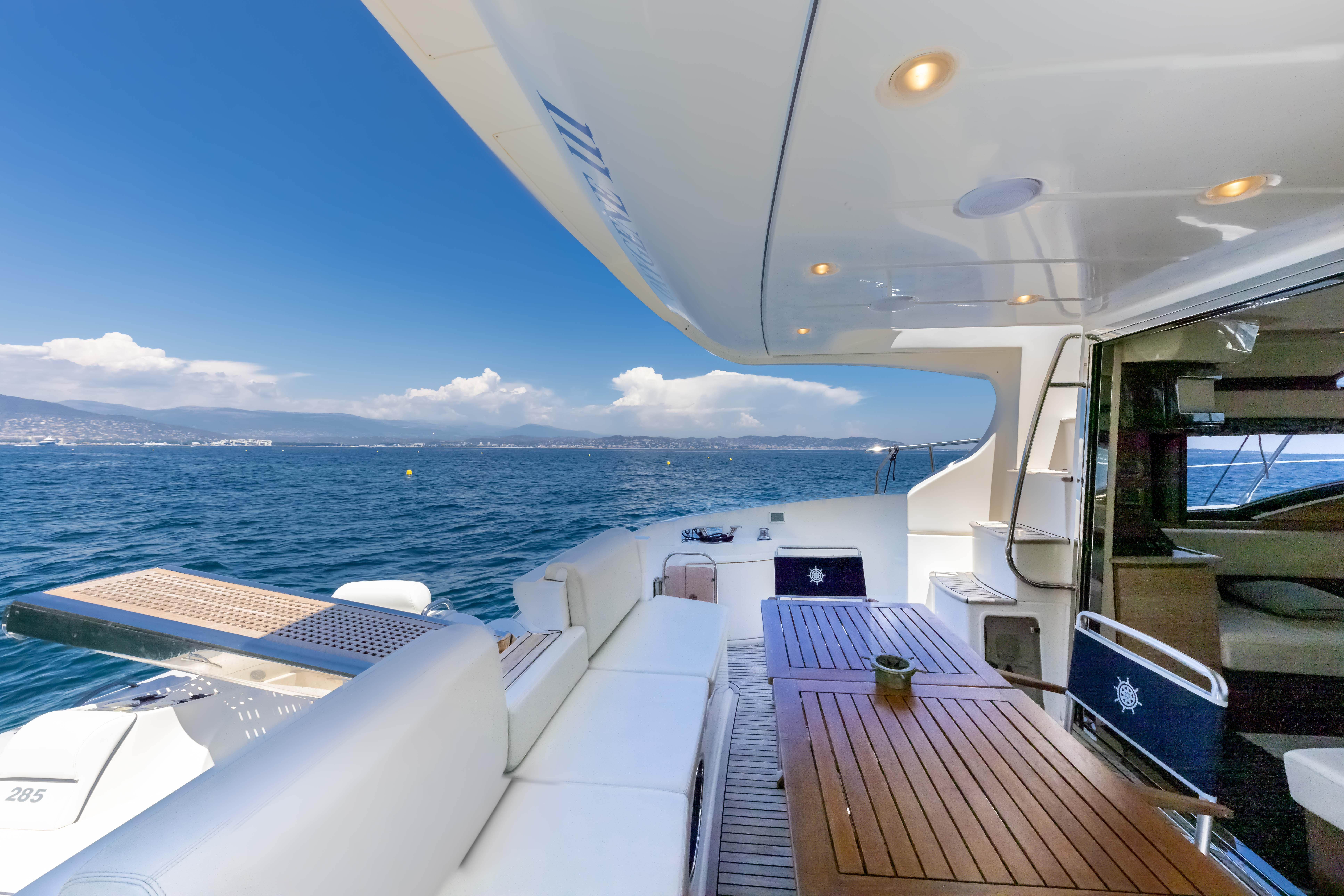 Luxurious 2010 Azimut 47 Fly yacht deck with ocean view and elegant seating area.