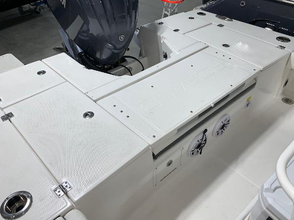 2024 Robalo 246 Cayman boat deck with storage compartments and outboard motor.