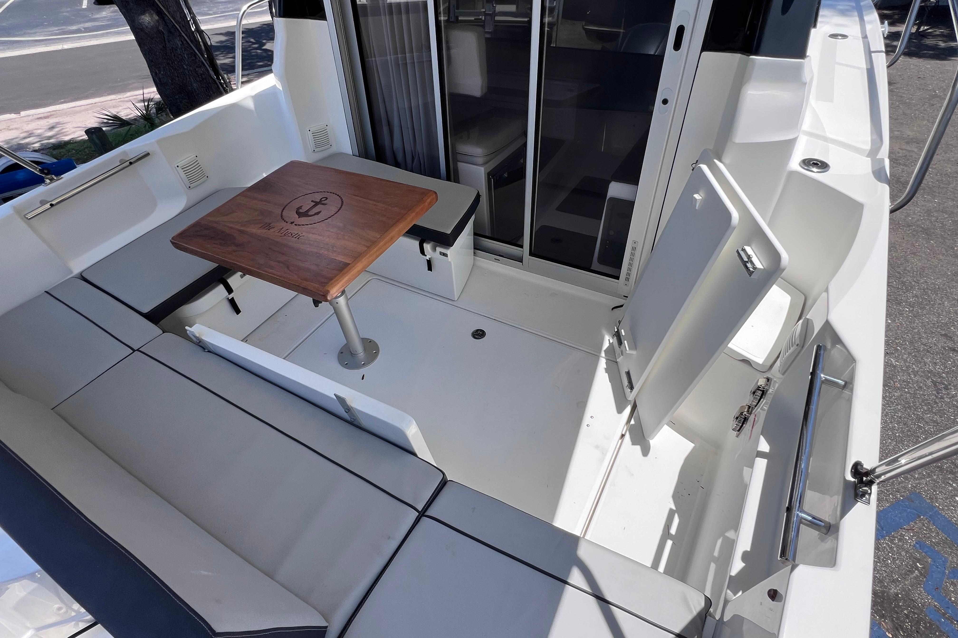 2021 Jeanneau NC Weekender 795 Series 2 boat interior with seating and wooden table.