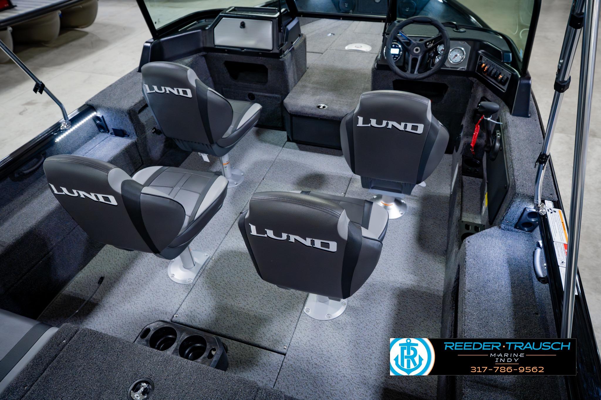 2026 Lund 1875 Impact XS boat interior with four seats and steering console.