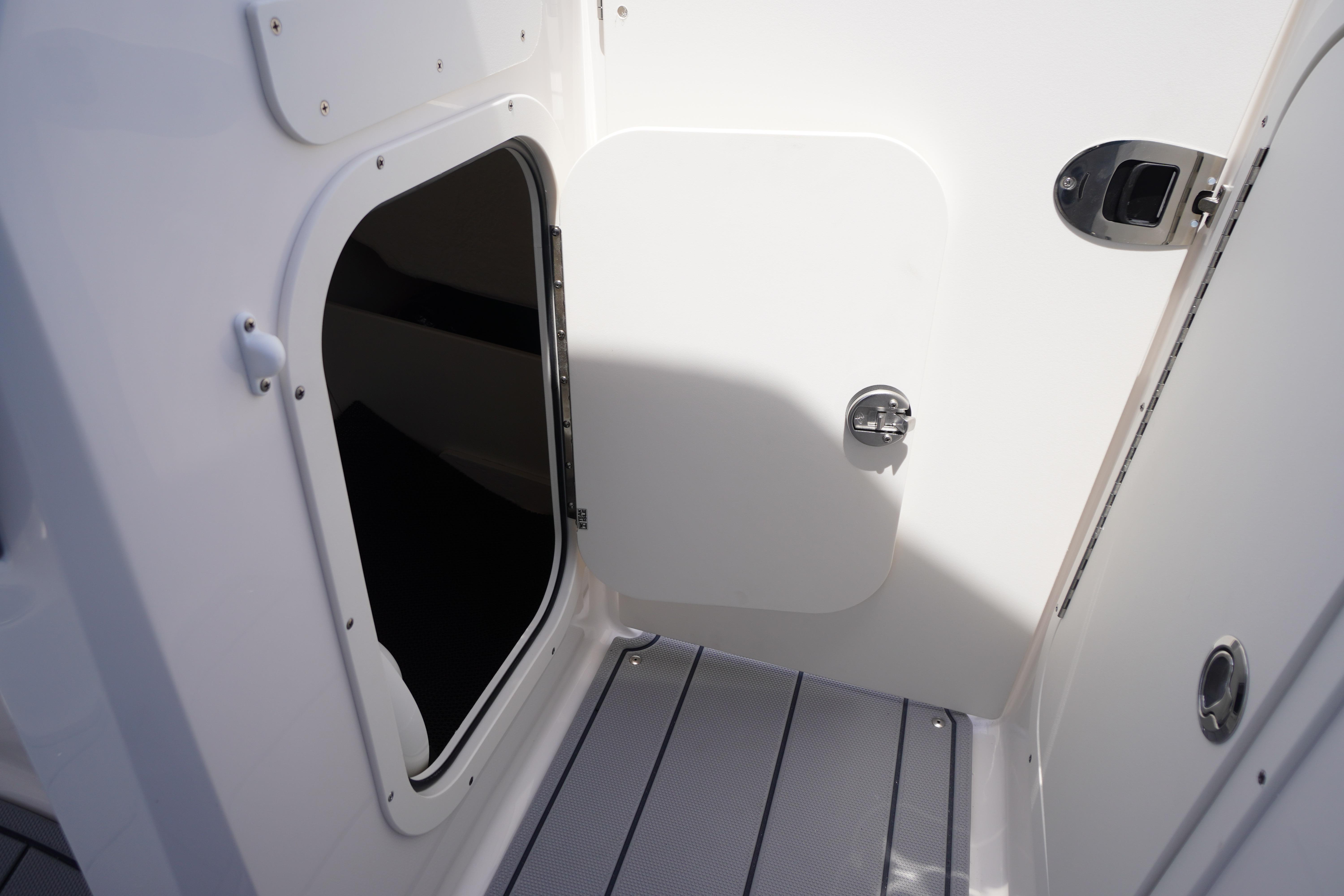 2026 Chaparral 23 SSi OB boat interior, featuring an open storage compartment and sleek design.