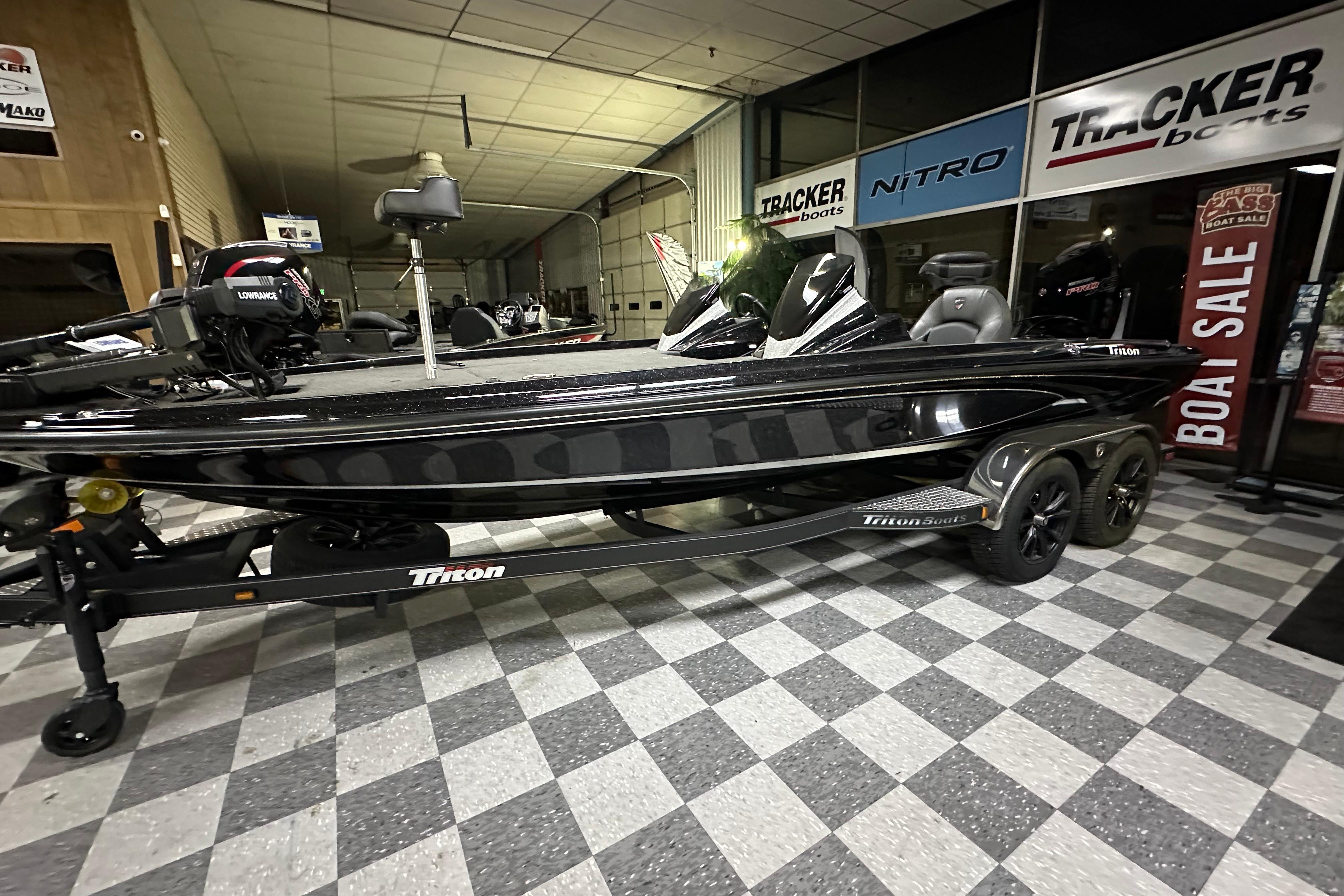 2025 Triton 21XP Patriot boat displayed indoors at a dealership.