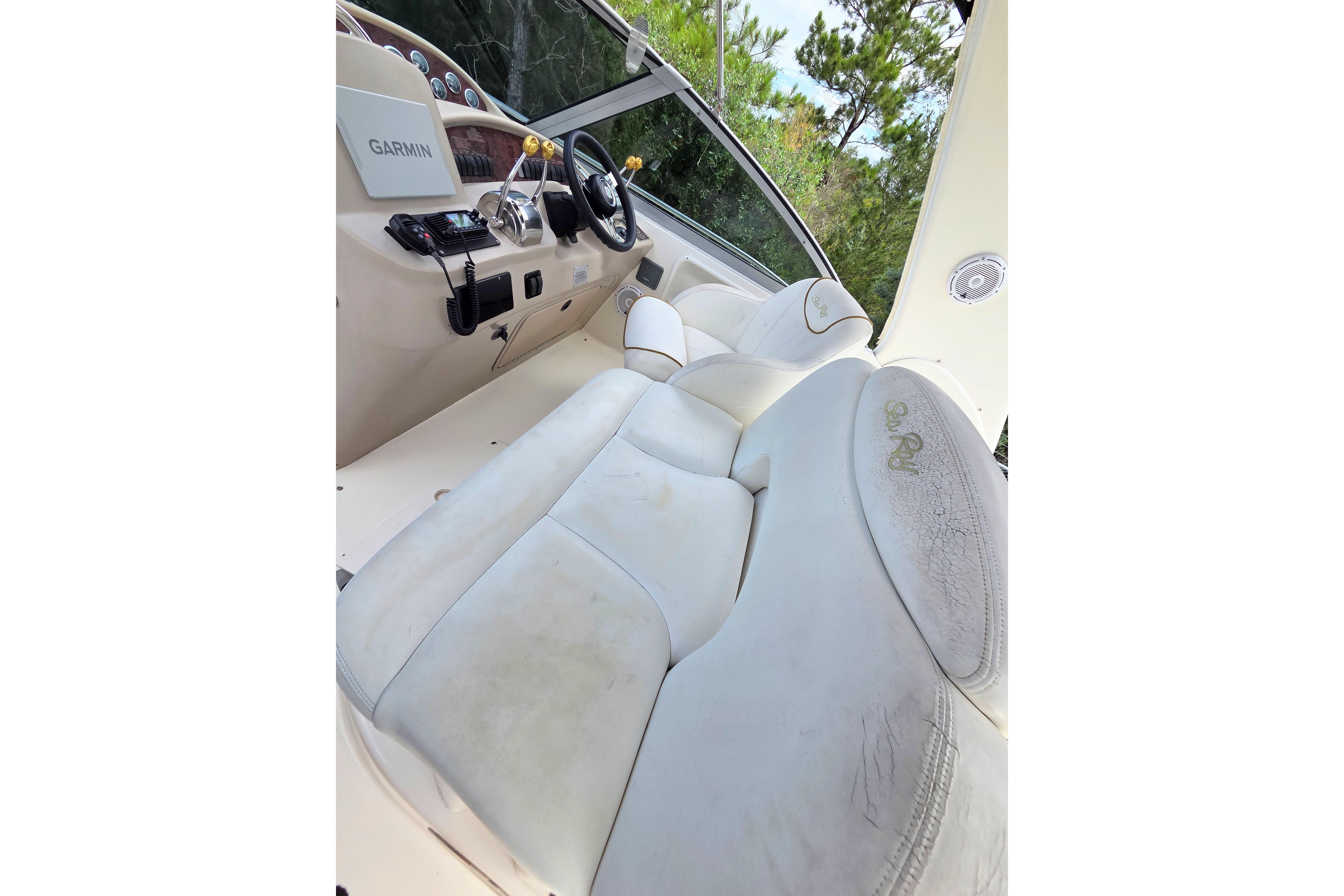 Cockpit of 2000 Sea Ray 340 Sundancer with Garmin navigation and white leather seating.
