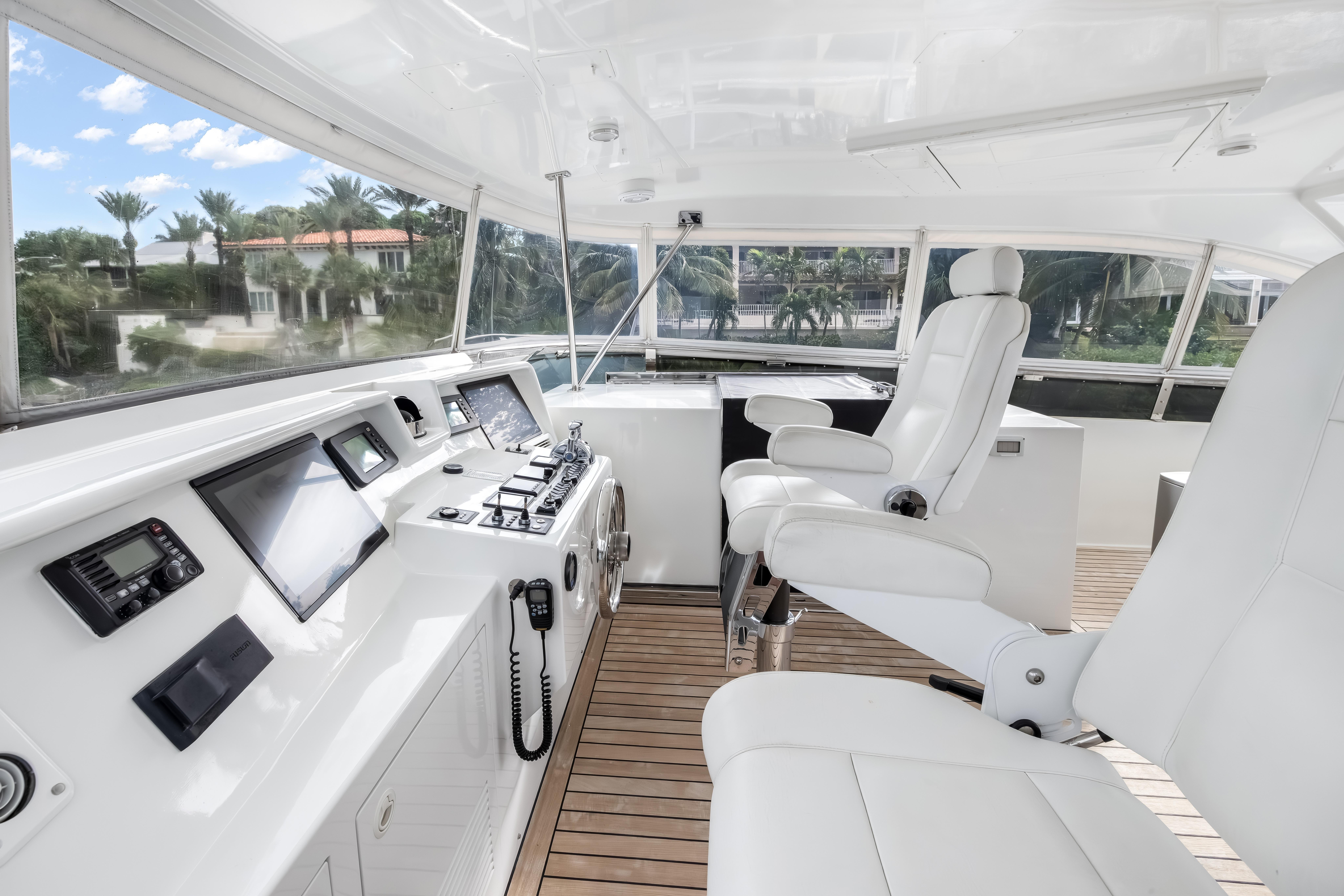 Luxurious helm of 2012 Cheoy Lee 84 Bravo yacht with modern controls and seating.