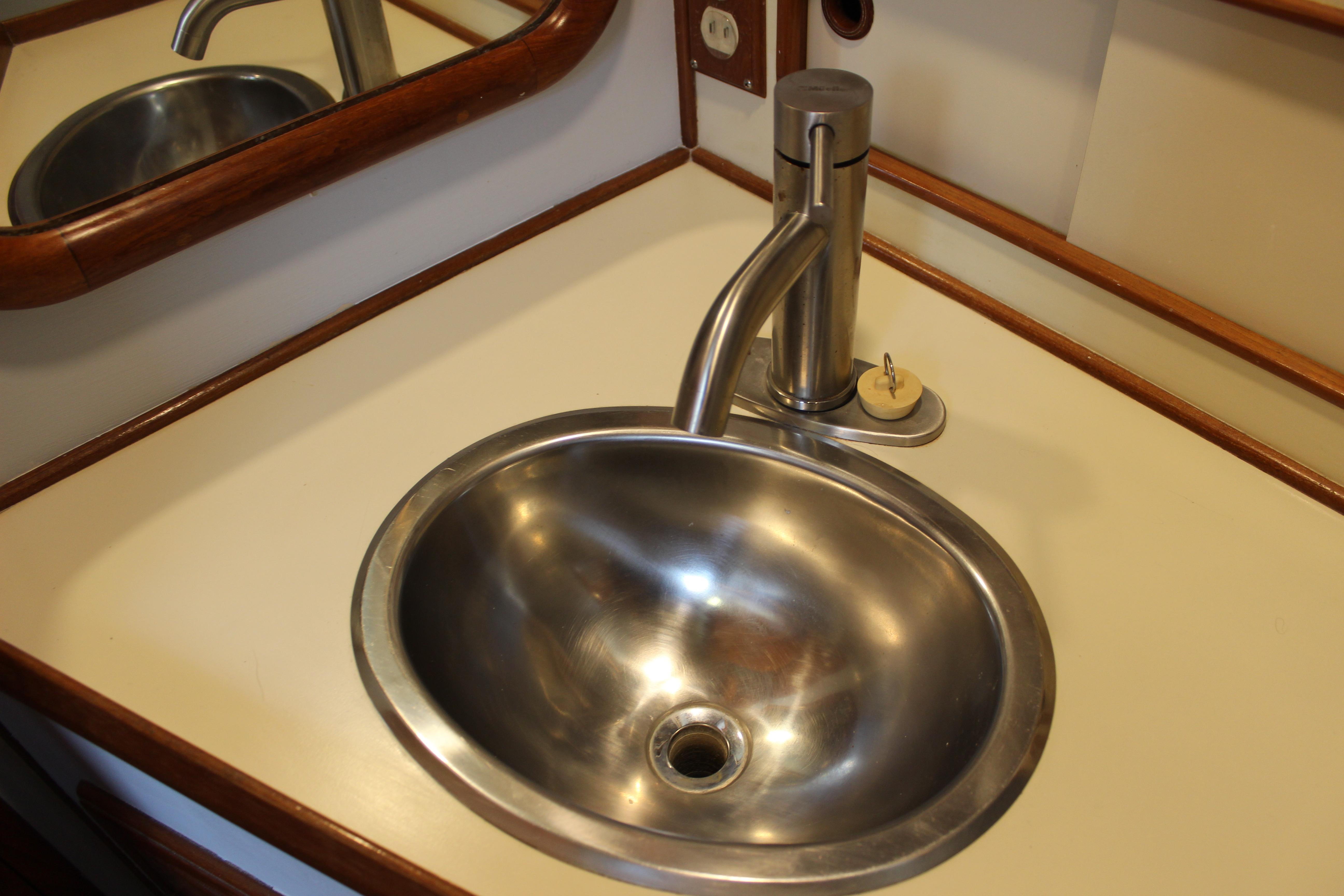 Stainless steel sink and faucet on 1986 Kha Shing Spindrift 46 yacht.