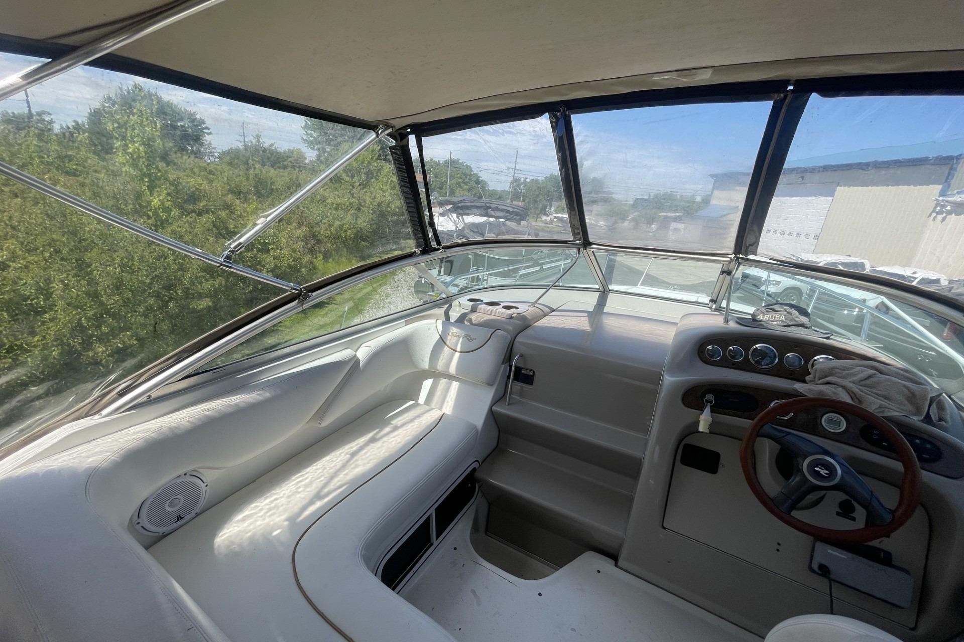 Interior view of a 2000 Sea Ray Sundancer 260 boat cockpit with steering wheel.