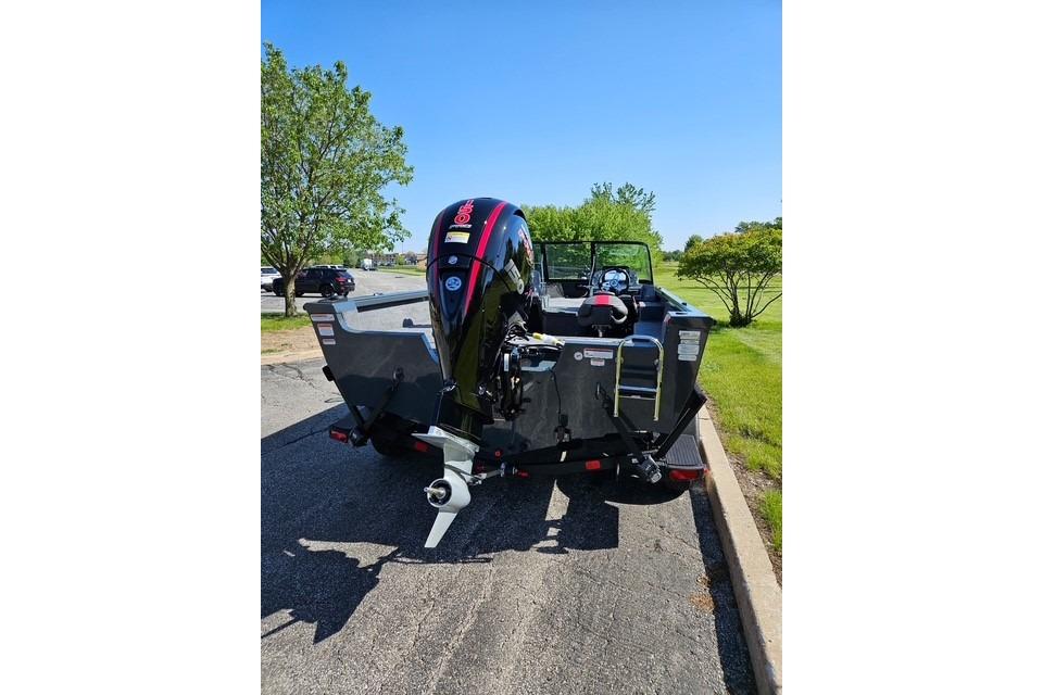 2026 Ranger VS1882SC Angler boat with outboard motor, parked on a sunny day.