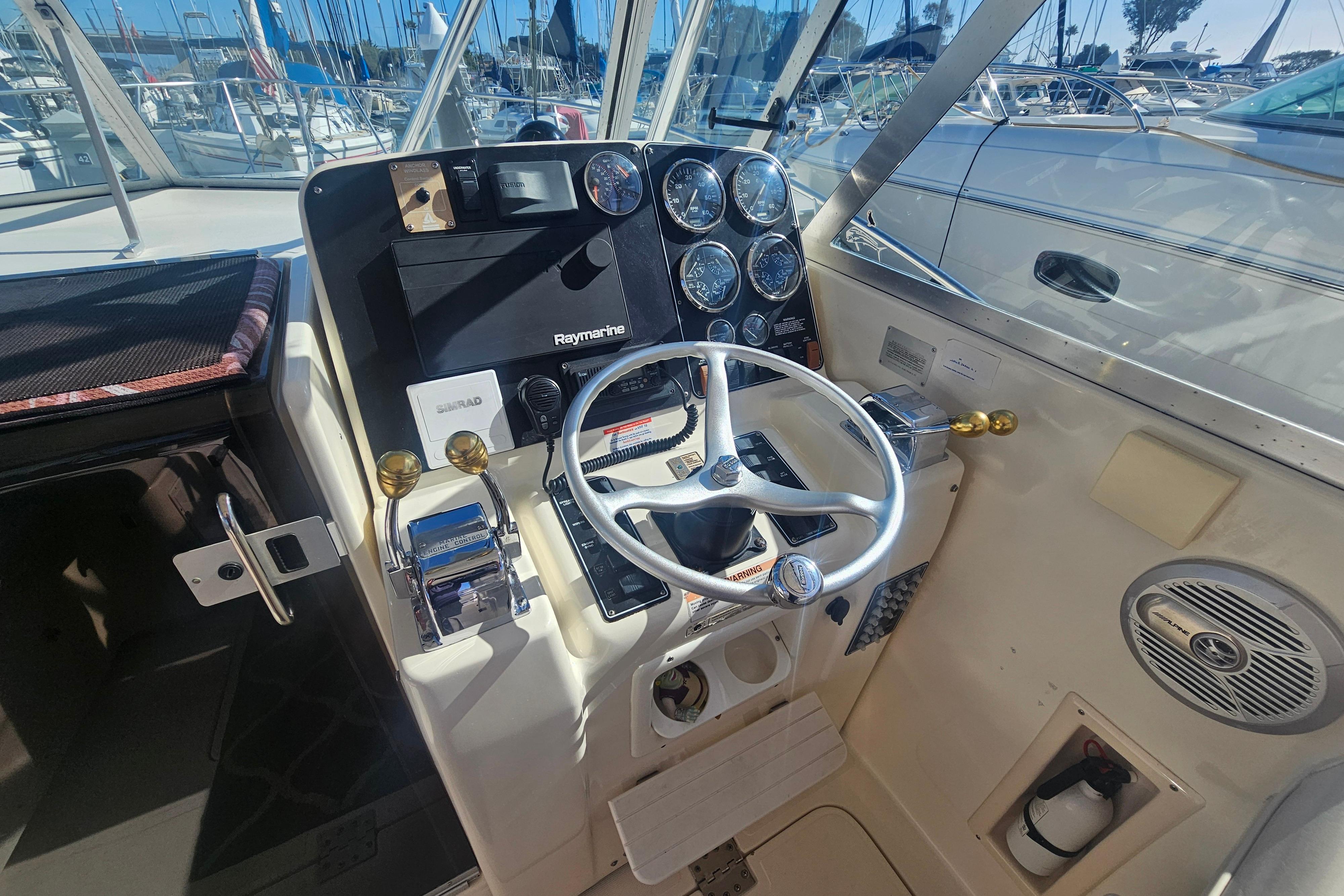 Helm of 2001 Pursuit 3000 Express boat with steering wheel and navigation instruments.