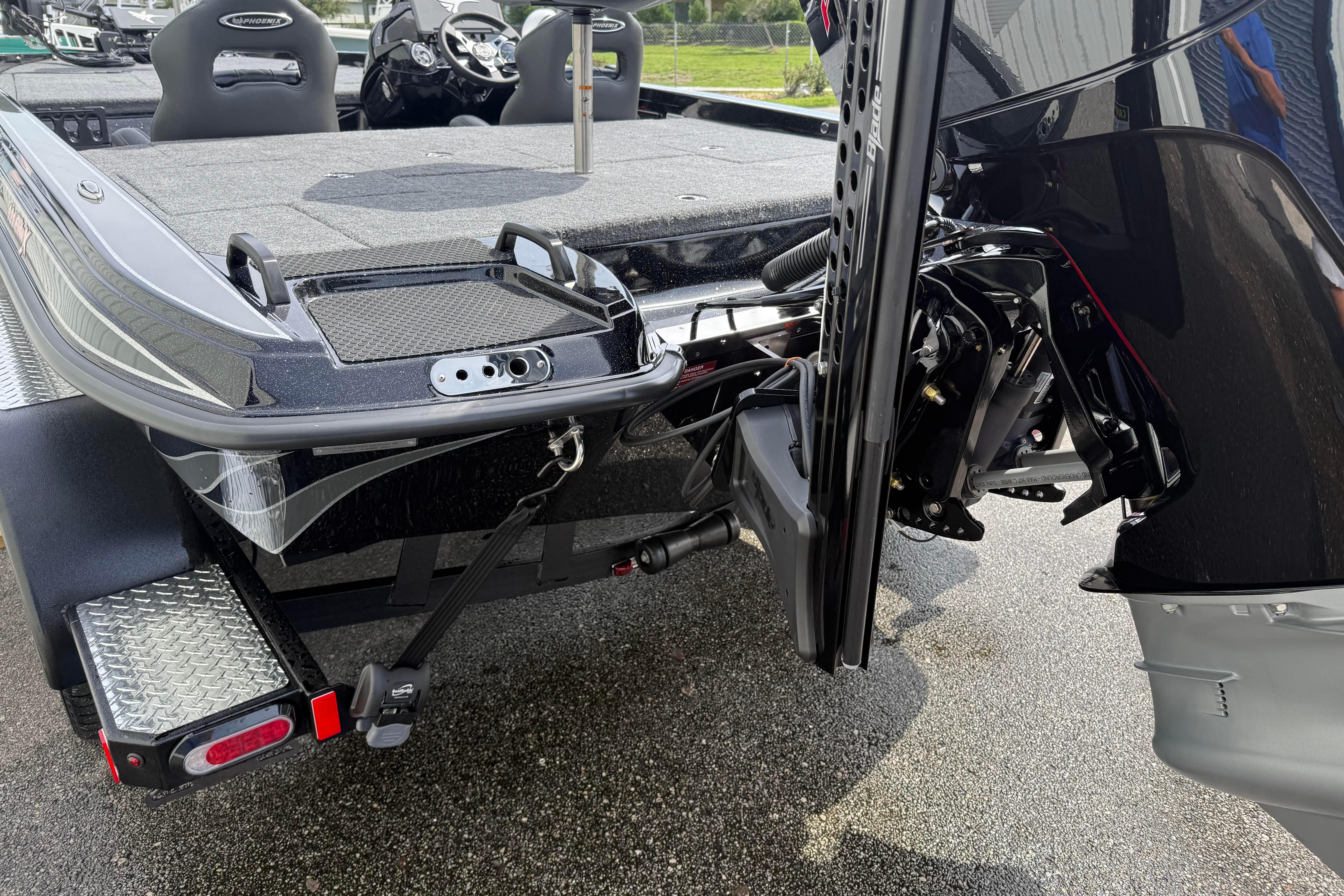 2027 Phoenix 921 Elite X boat rear view, showcasing motor and deck details.