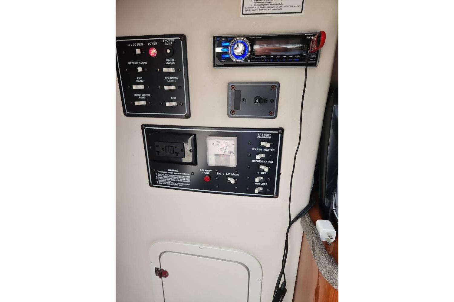 Control panel of a 2001 Crownline 242 CR boat with various switches and gauges.