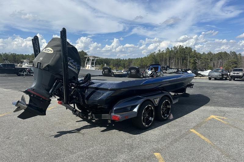 2020 Skeeter FXR21 boat on trailer in parking lot under blue sky.
