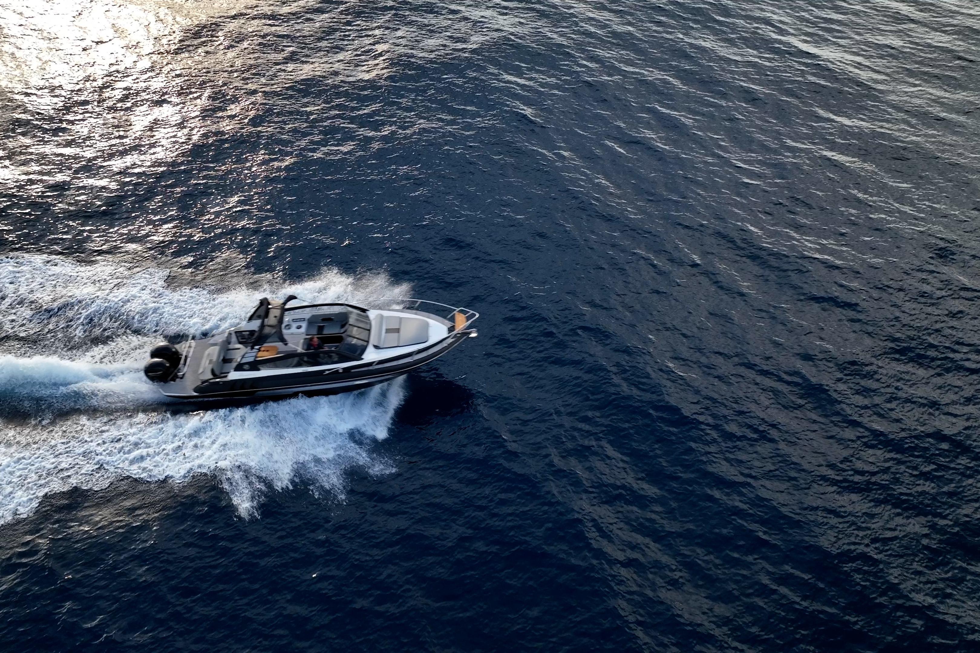 Aerial view of 2027 Hanover 305 boat cruising on open water.