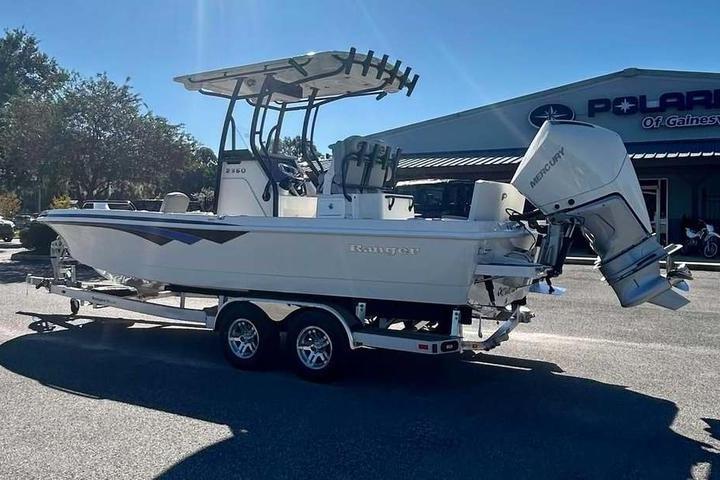 2026 Ranger 2360 Bay boat on trailer, parked outdoors near dealership.