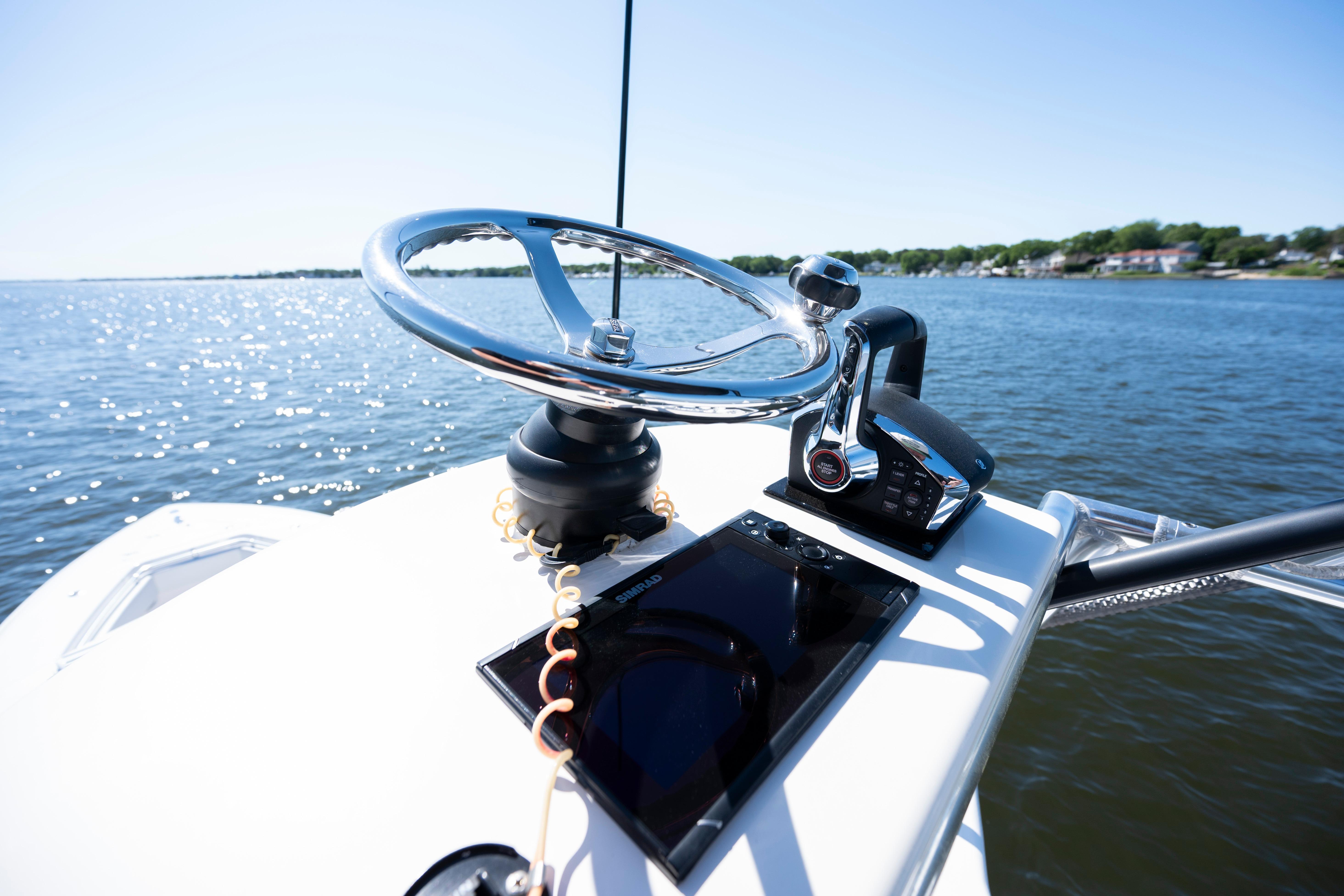 Steering console of 2015 Contender 39 ST boat on a sunny day.