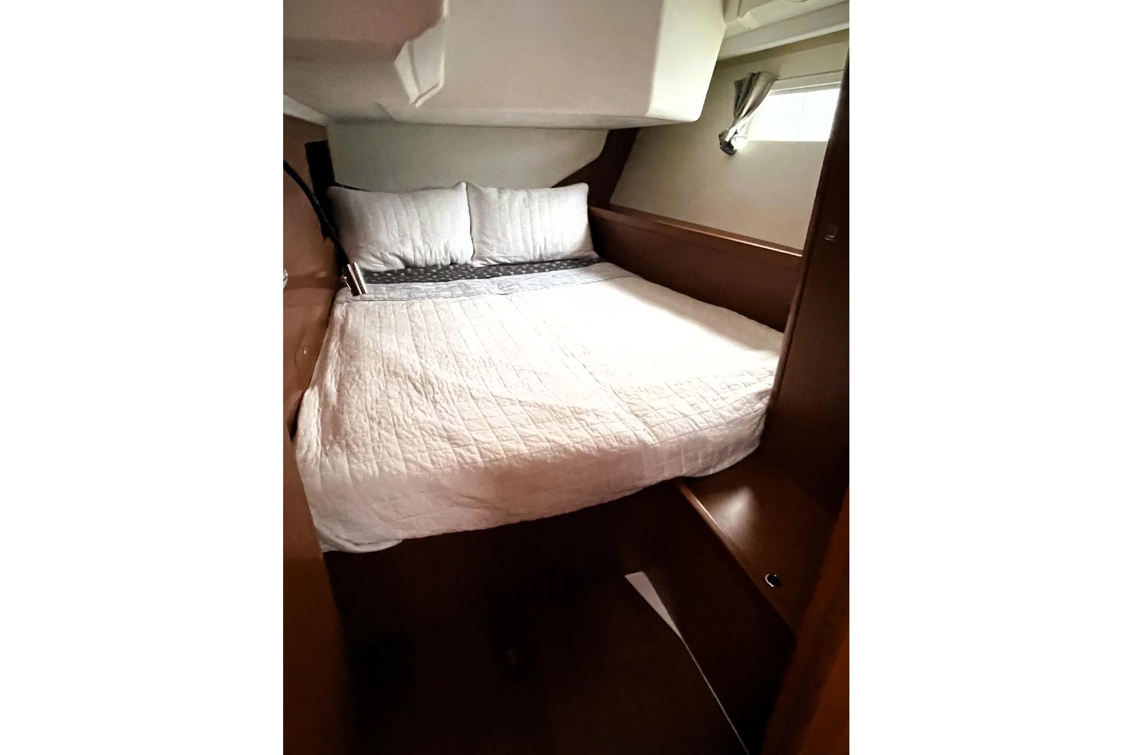 Cozy cabin interior of 2018 Beneteau Oceanis 45 yacht with comfortable bedding.