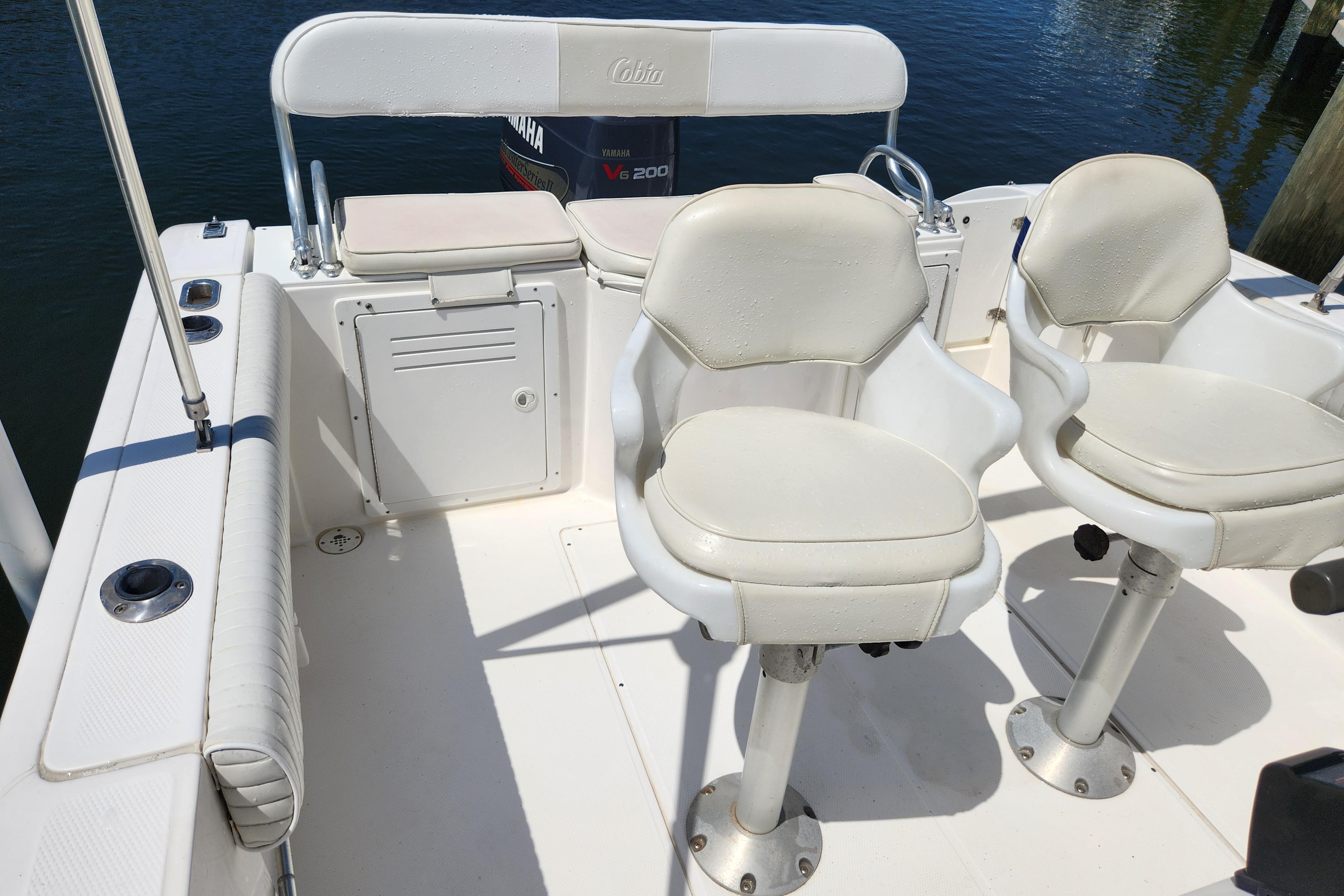 2001 Cobia 234 Center Console boat interior with white seating and Yamaha engine.