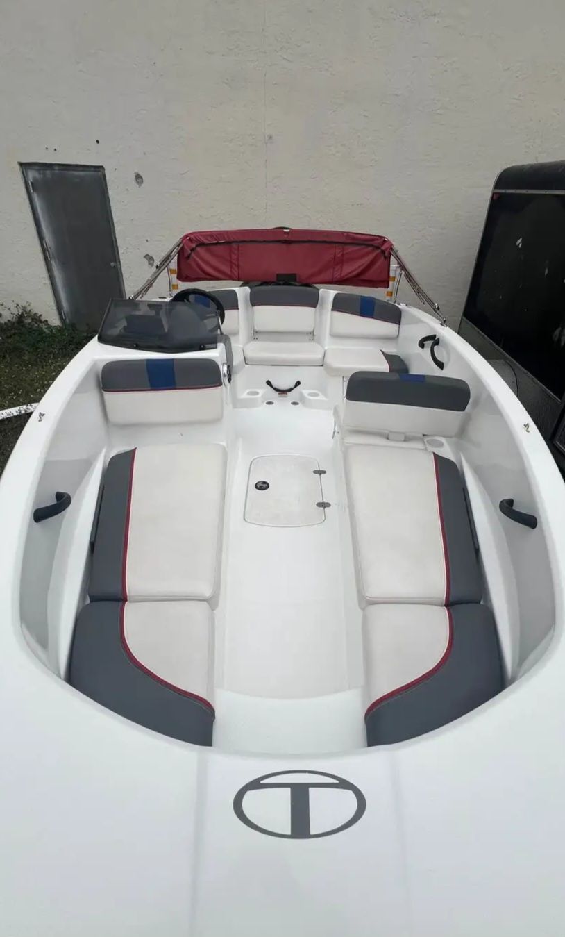 2022 Tahoe T16 with white hull and gray upholstery, red bimini top, spacious deck layout.