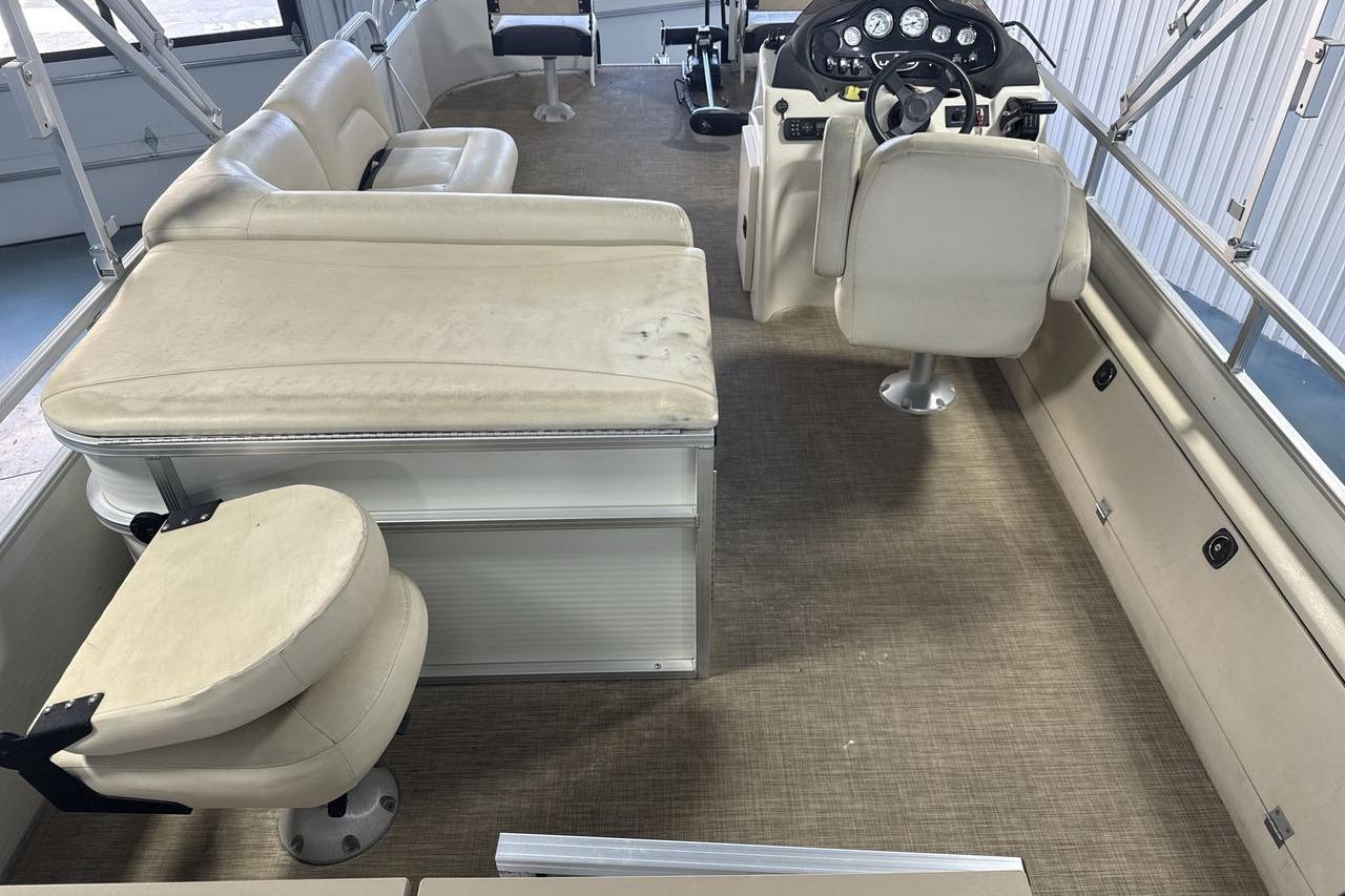 2018 Landau Alure 212 Fish boat interior with beige seating and steering console.