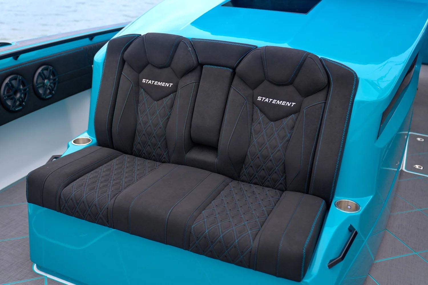 Manufacturer Provided Image: Luxurious seating on 2025 Statement 430 Tigress boat, featuring sleek black and blue design.