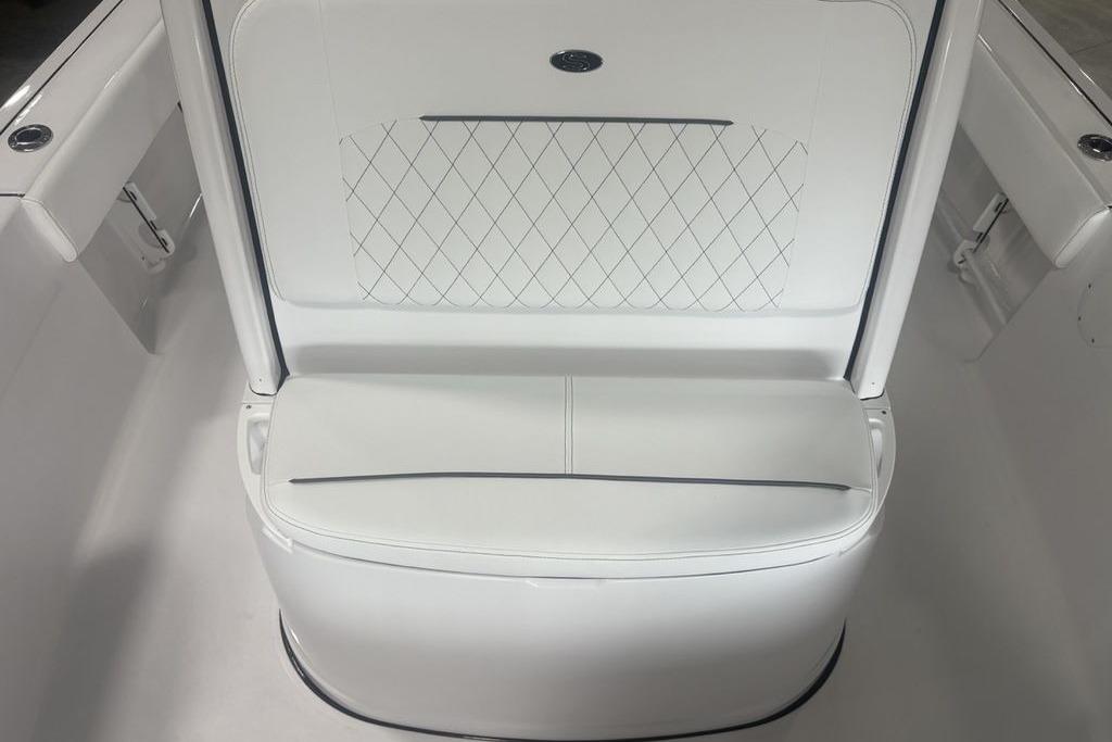 2026 Sportsman Masters 227 boat seat with white upholstery and diamond stitching.