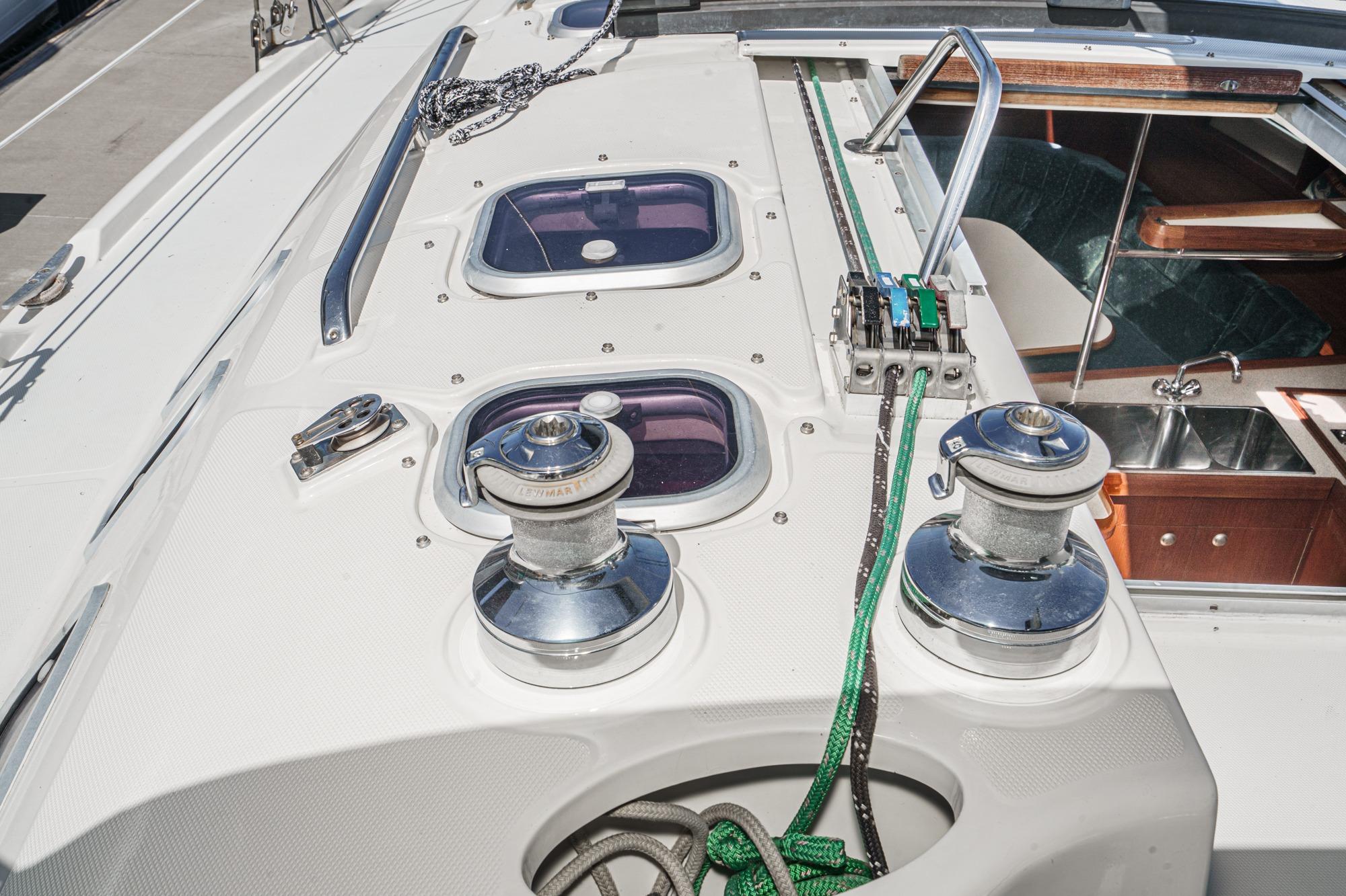Deck of 1996 Hunter 376 sailboat with winches and hatch windows.