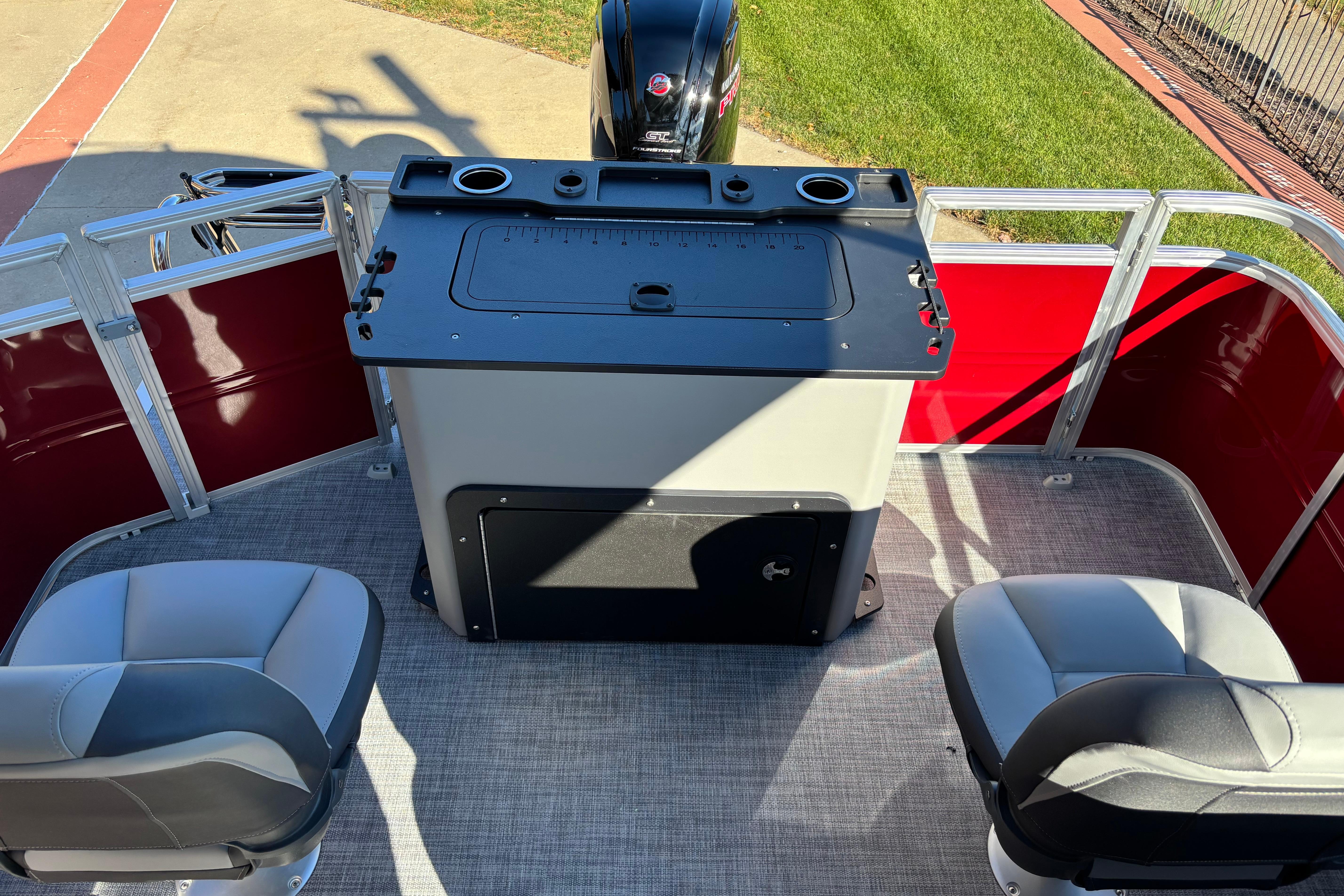 2026 Sun Tracker SportFish 20 DLX boat interior with seating and fishing station.
