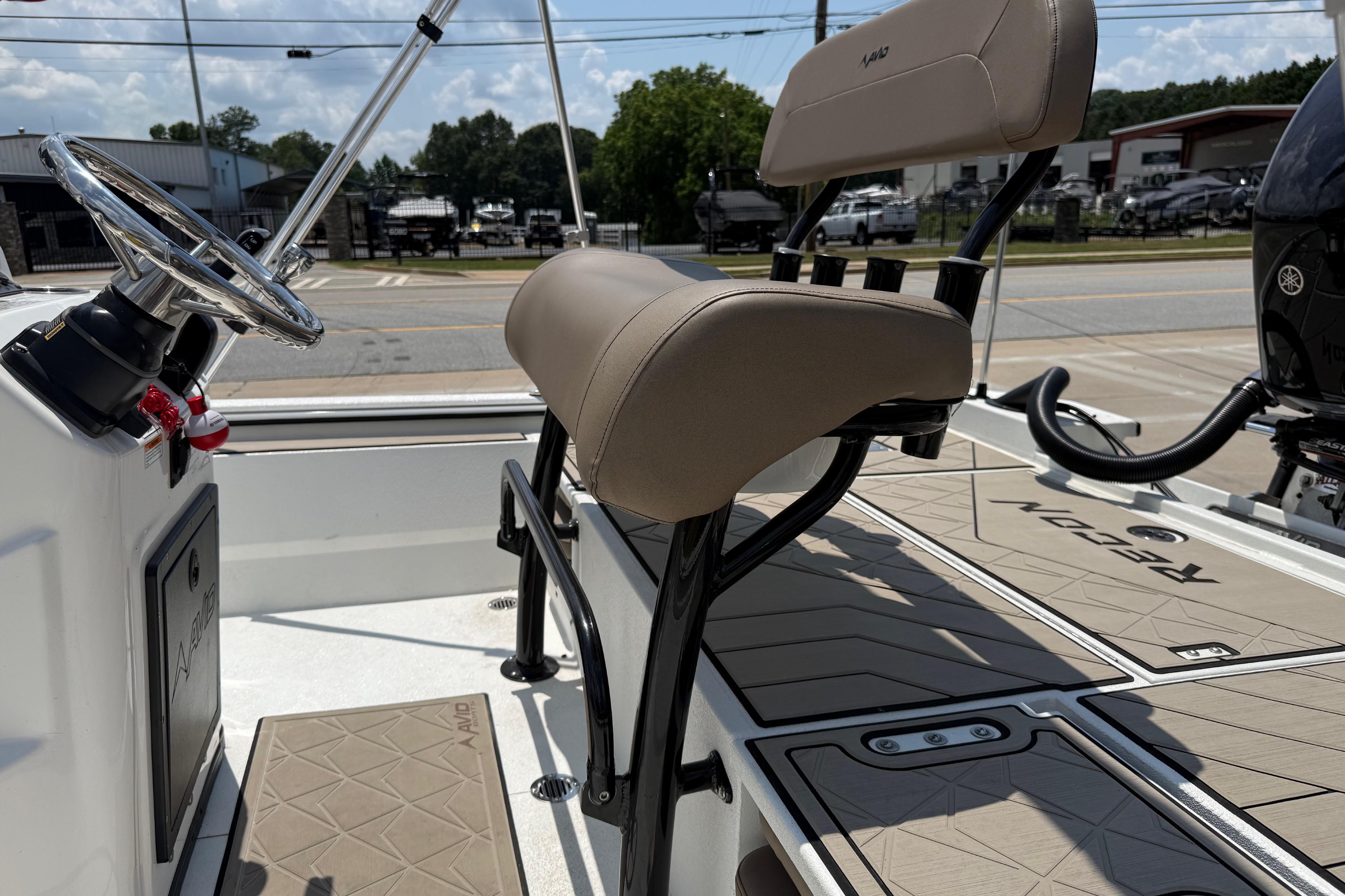 Interior view of 2025 Avid 22 Recon boat, featuring steering wheel and seating.