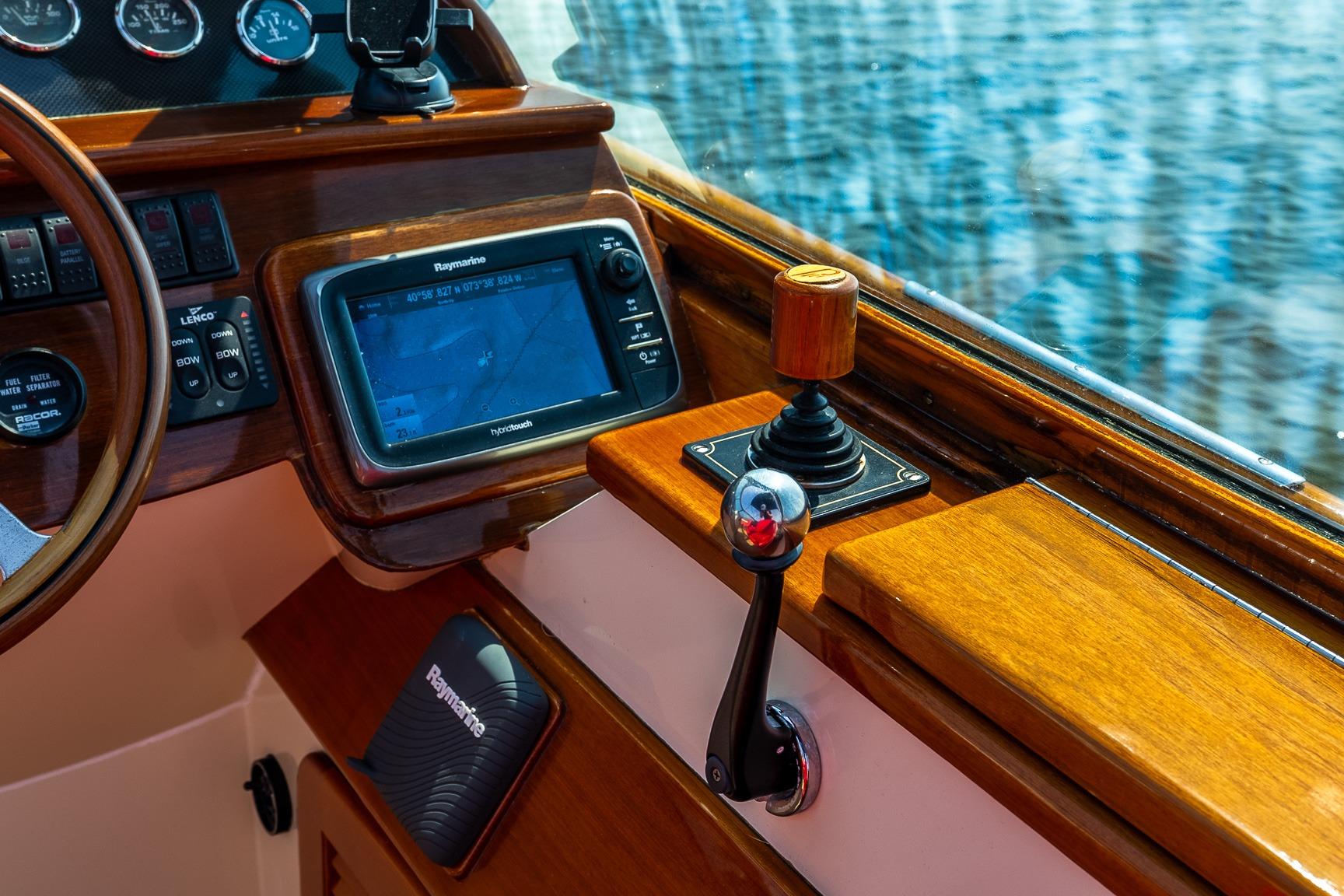 2005 Hinckley Talaria 29R boat dashboard with navigation controls and Raymarine display.