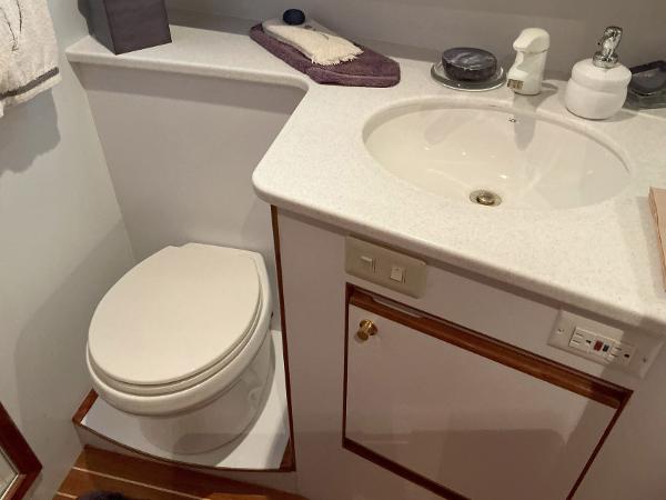 Bathroom interior of 2000 Novatec Islander 55 yacht with sink and toilet.
