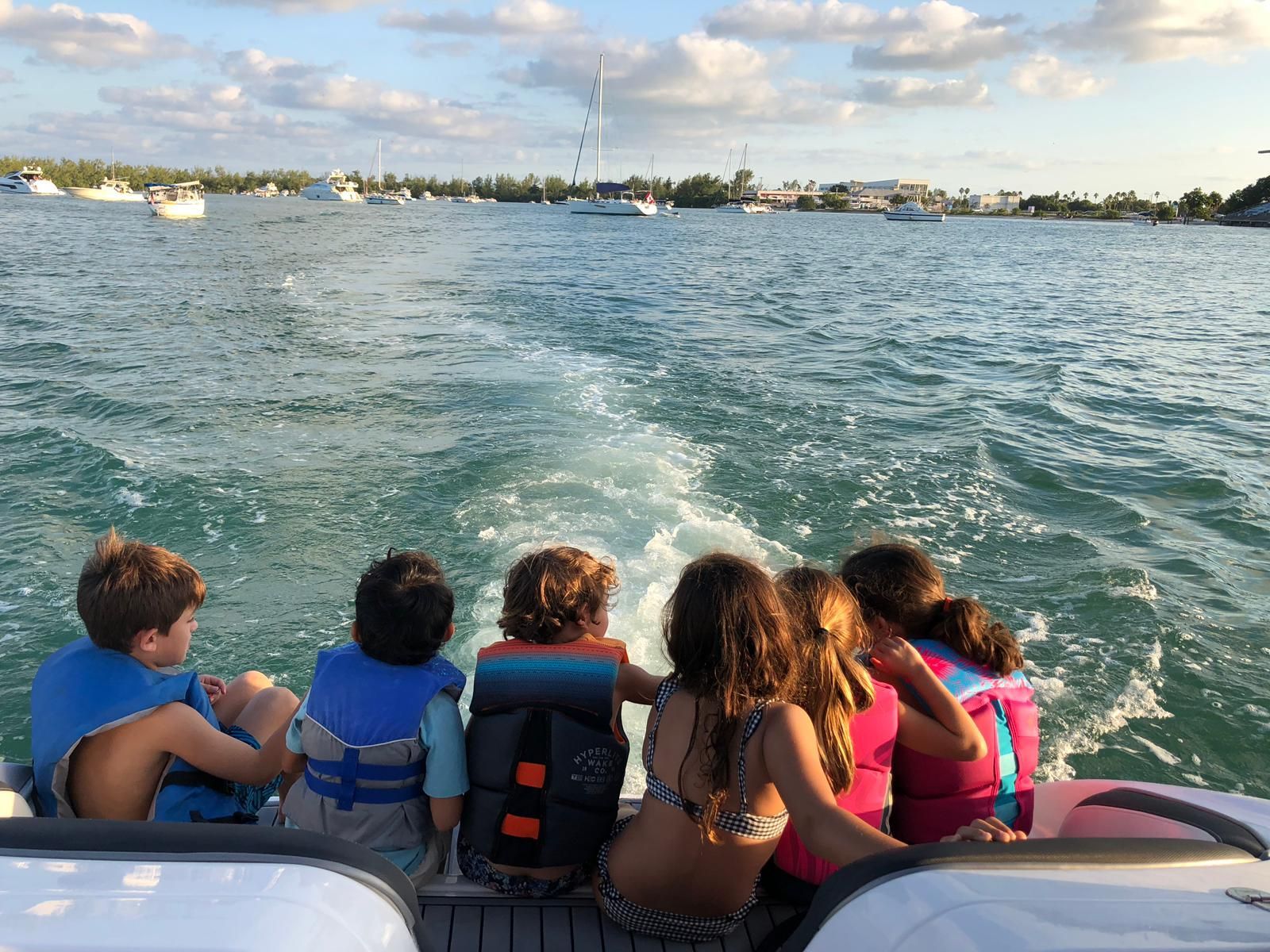 Children enjoying a boat ride on a Yamaha AR240.