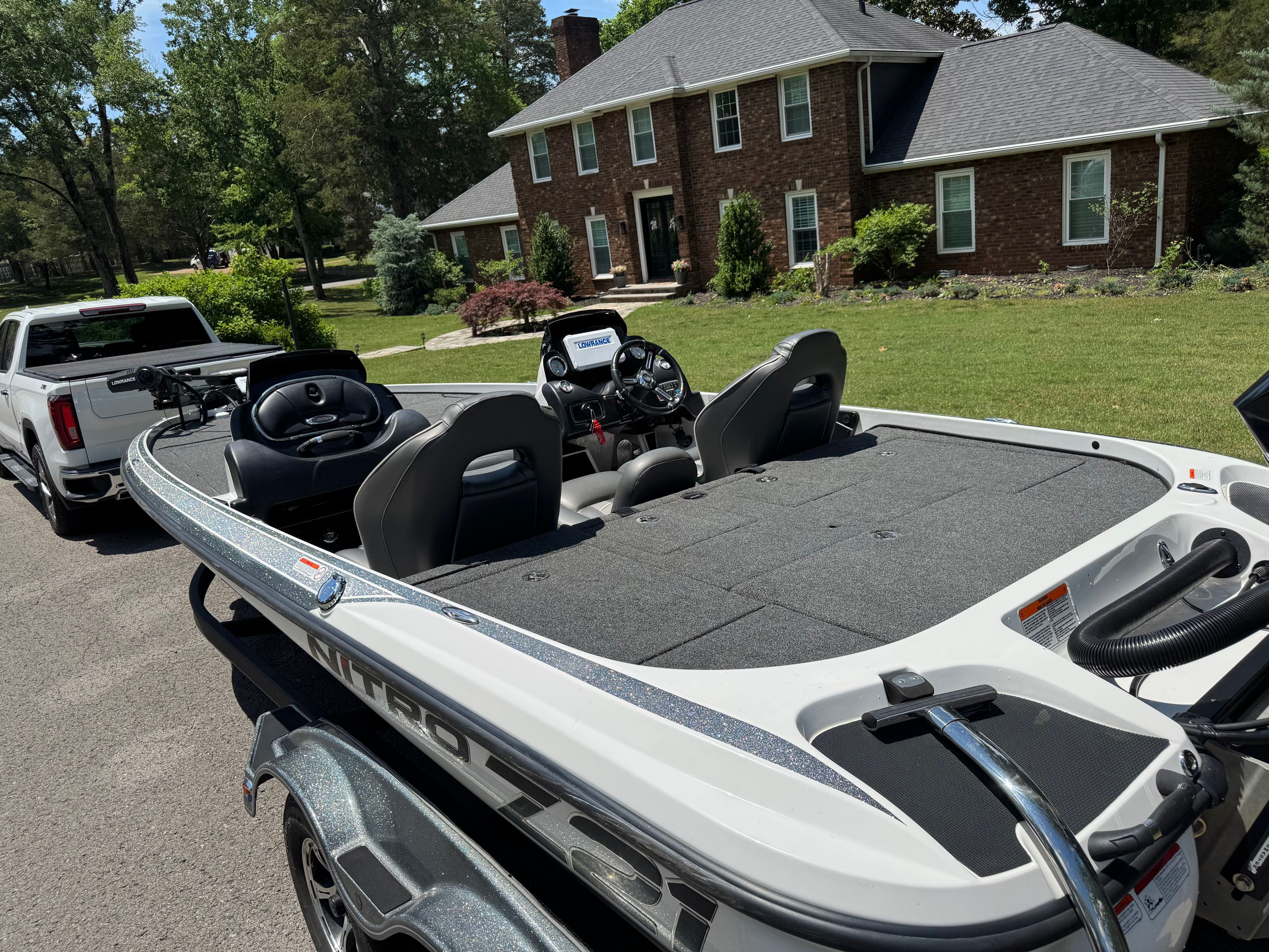 2019 Nitro Z21 boat parked in front of a brick house.