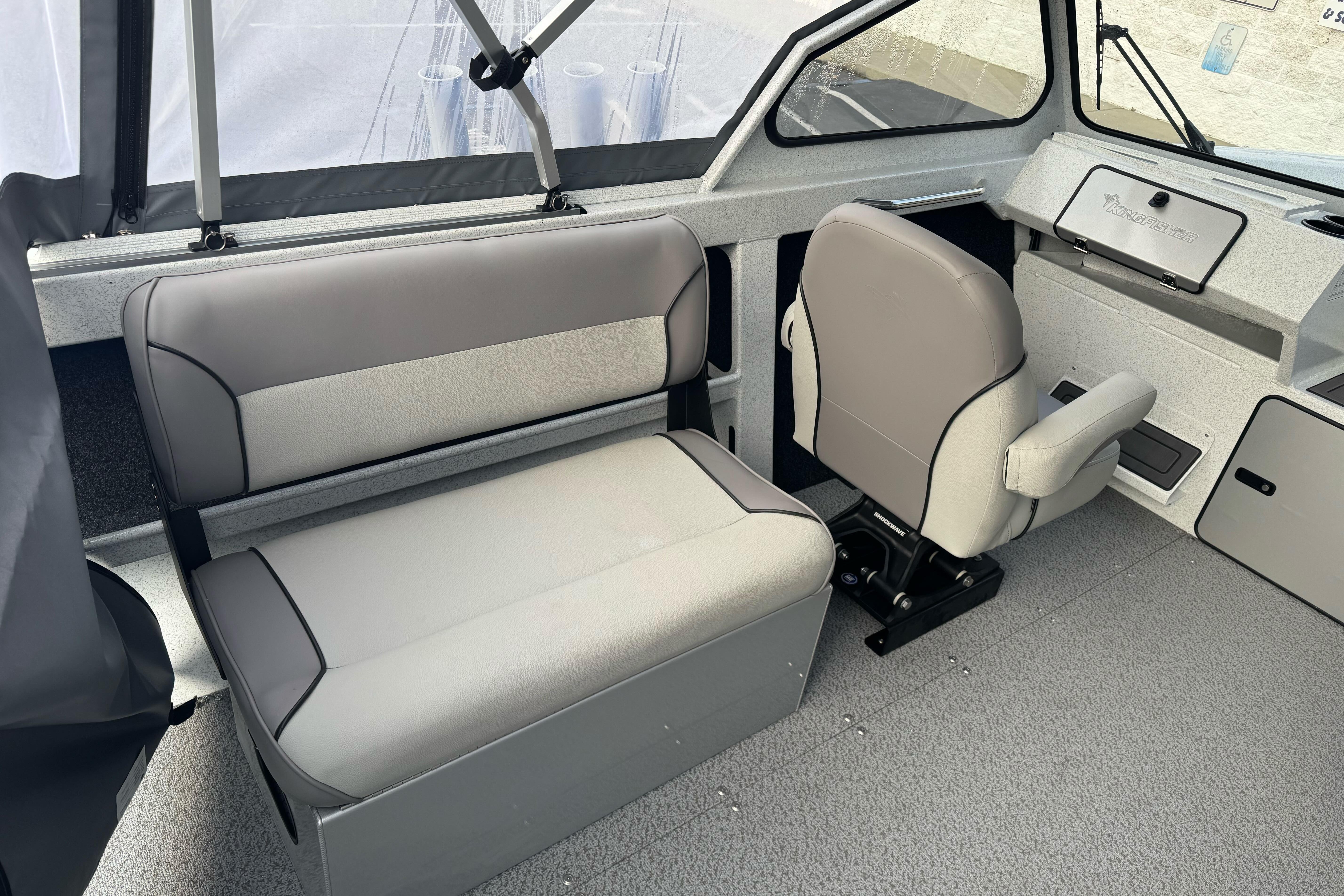 Interior of 2026 KingFisher 2025 Escape boat with gray seating and dashboard.