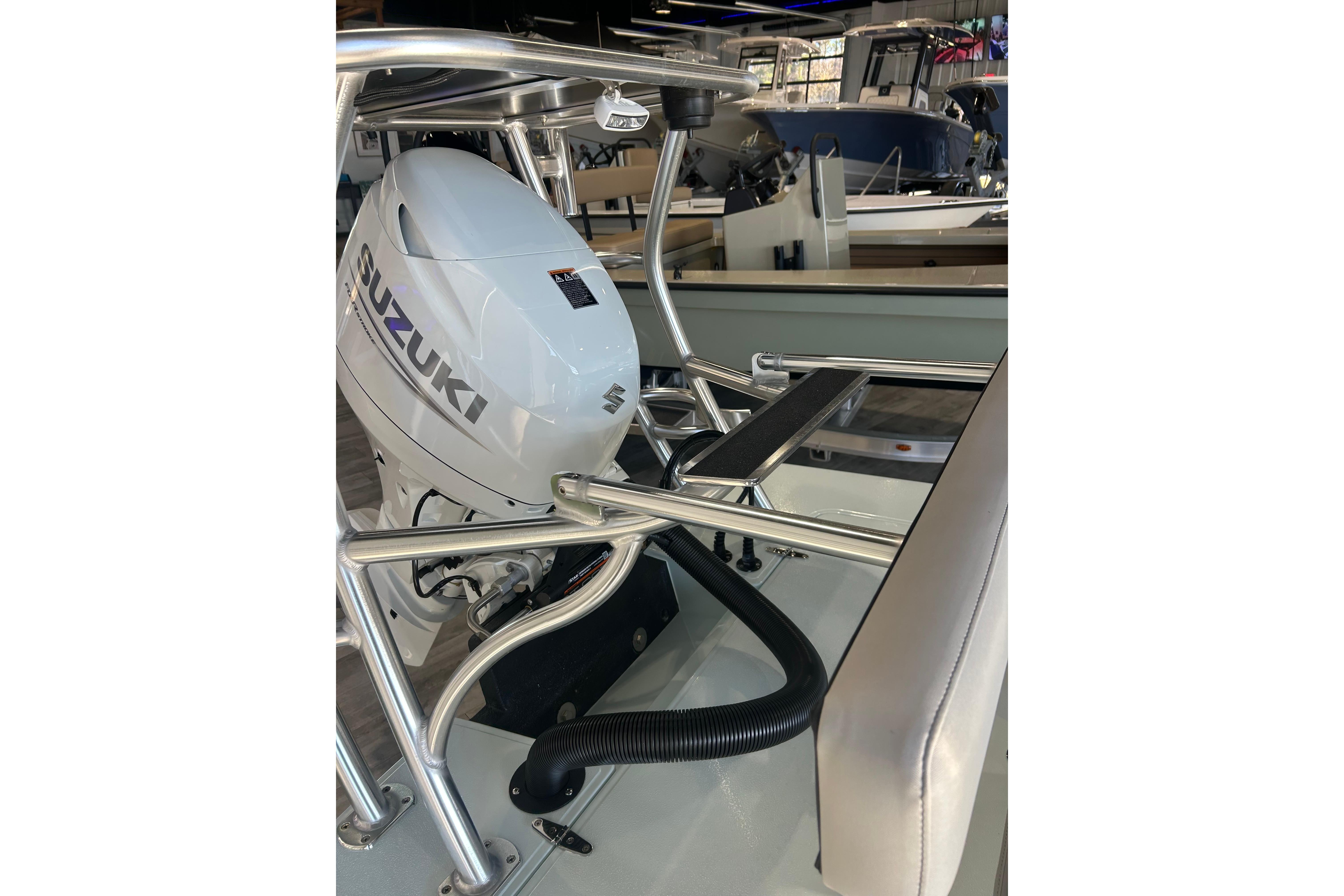 2026 East Cape Evo 17X boat with Suzuki outboard motor in showroom.
