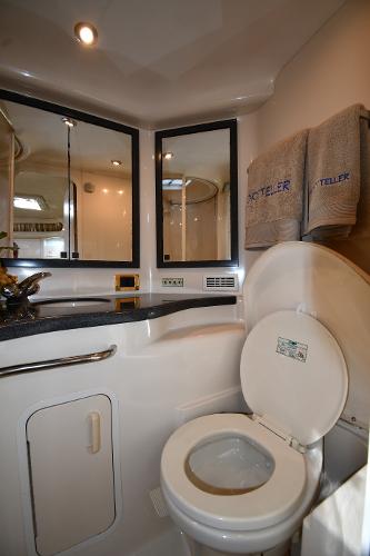 Bathroom interior of 1997 Sea Ray 400 Sundancer yacht with modern fixtures and towels.