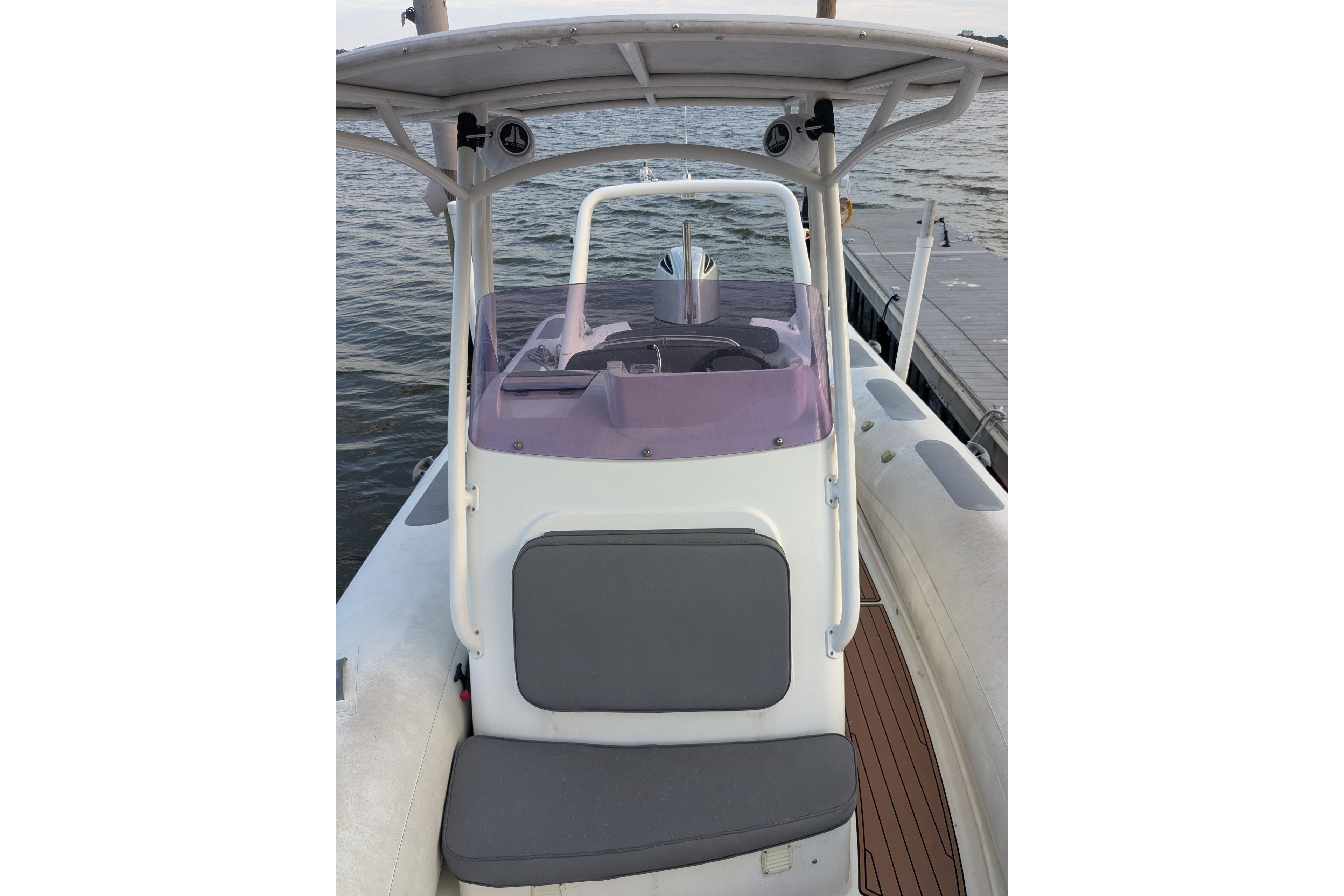 2016 Brig E780 boat with console and seating, docked by the water.