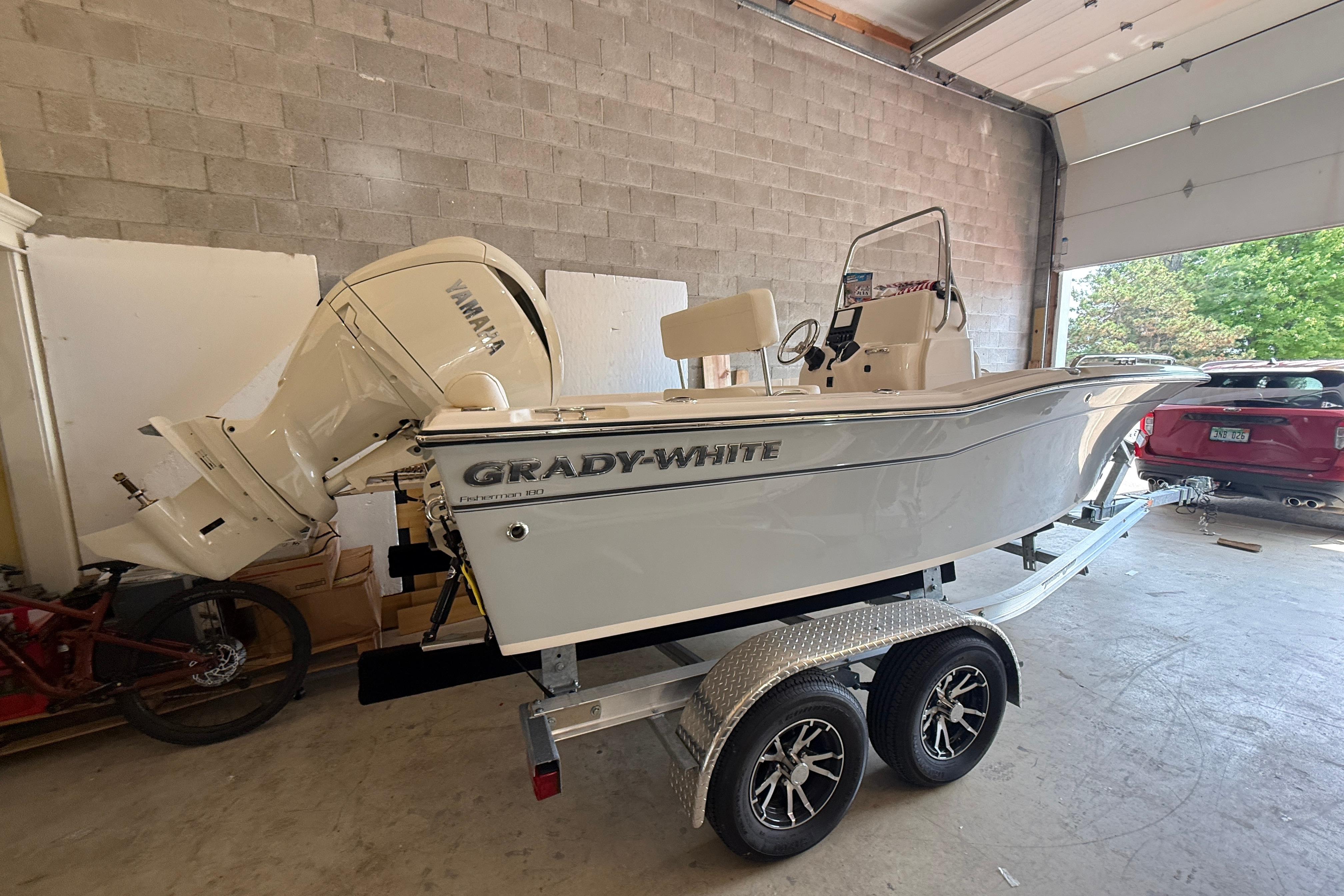 2025 Grady-White Fisherman 180 boat on trailer in garage setting.