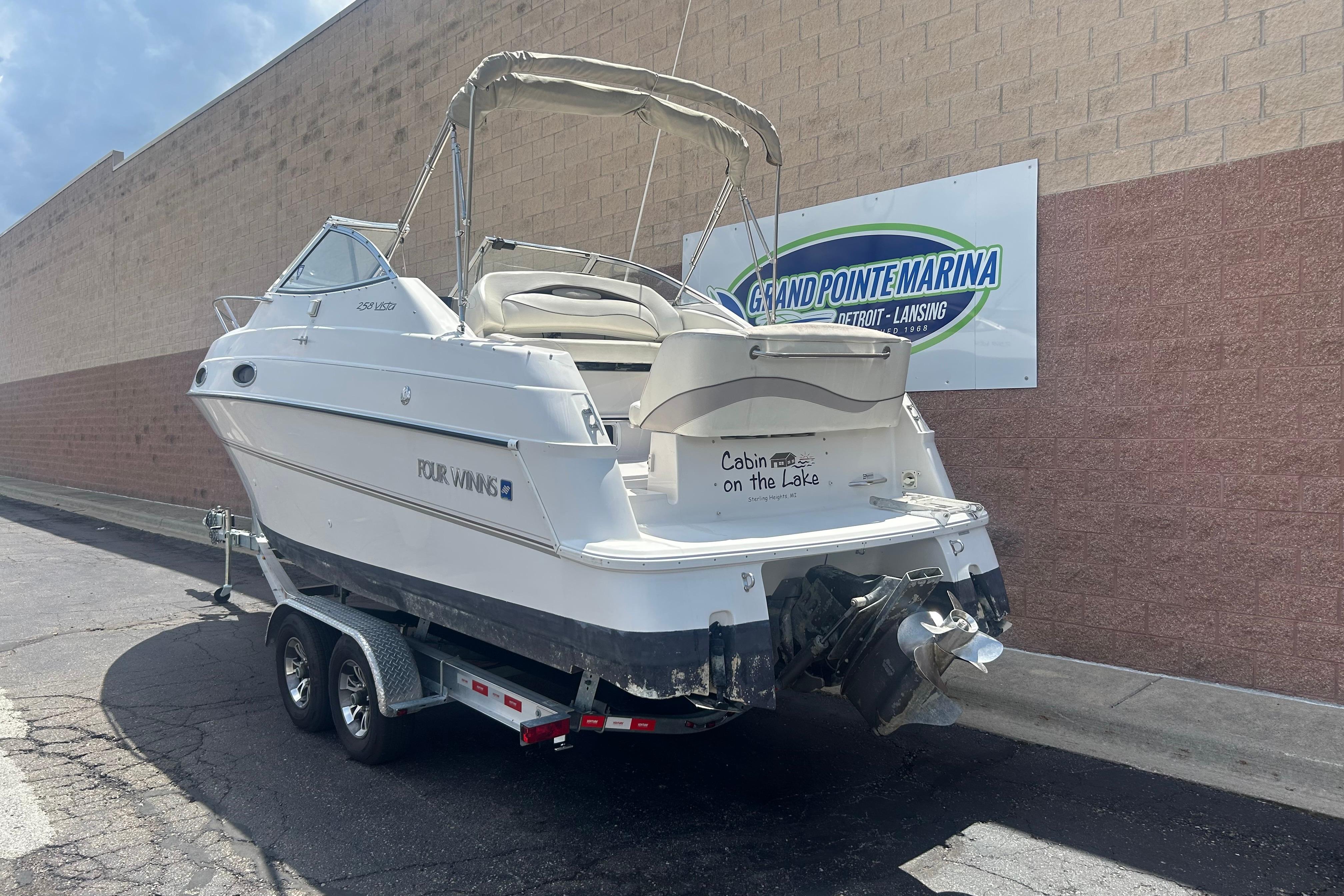 1998 Four Winns 258 Vista boat on trailer at Grand Pointe Marina.