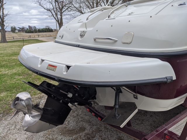The image shows the stern of a 2003 Crownline 270 BR boat with an outboard motor.