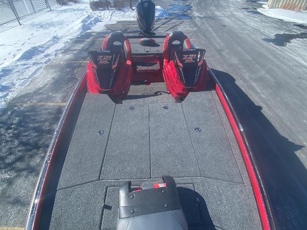 2025 Nitro Z21 XL Pro boat with spacious deck and dual seats, parked on snowy pavement.