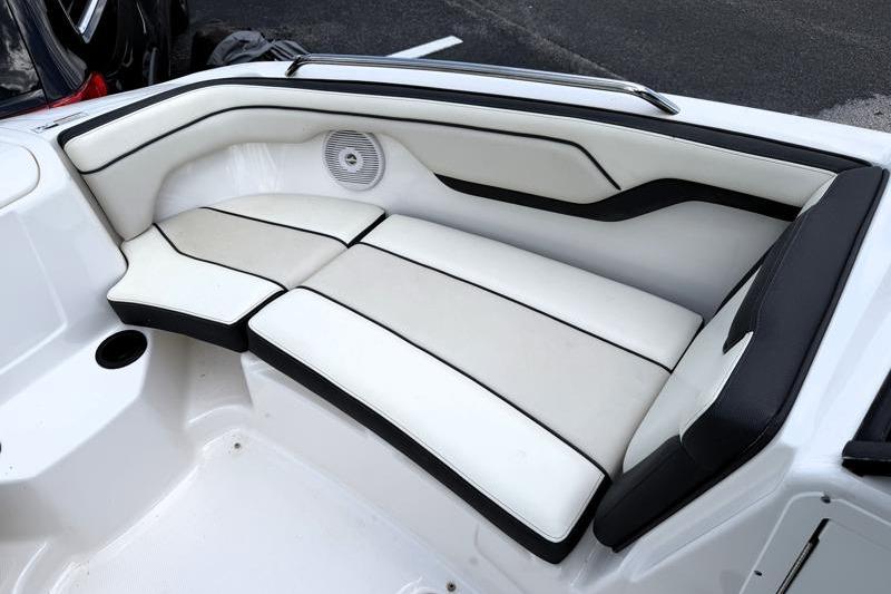 2017 Yamaha Boats SX210 interior with white cushioned seating and speaker.