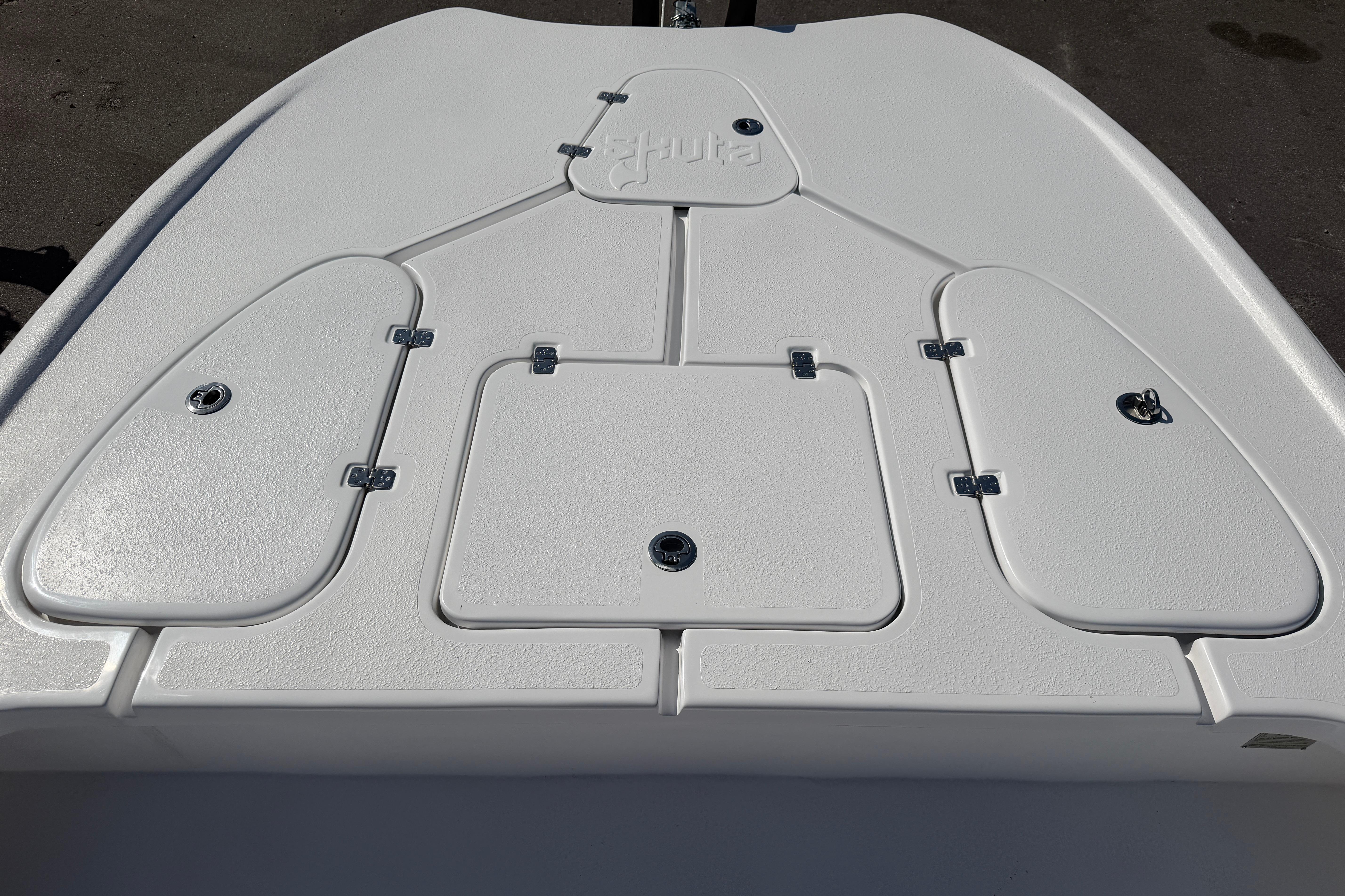 2026 Skuta 24 Cat boat deck with storage compartments and Skuta logo.