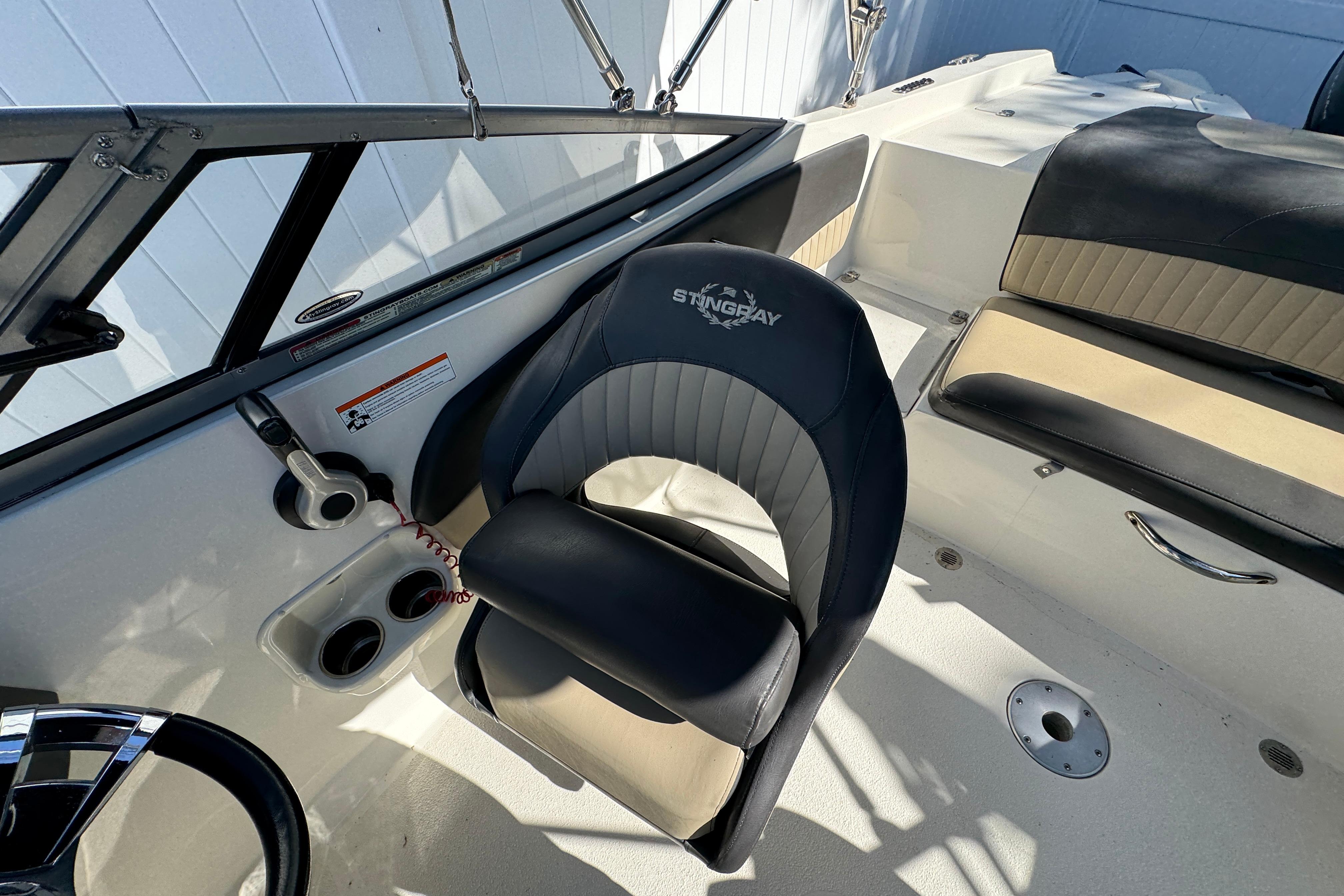 Interior of a 2018 Stingray 204 LR boat featuring a sleek captain's chair.