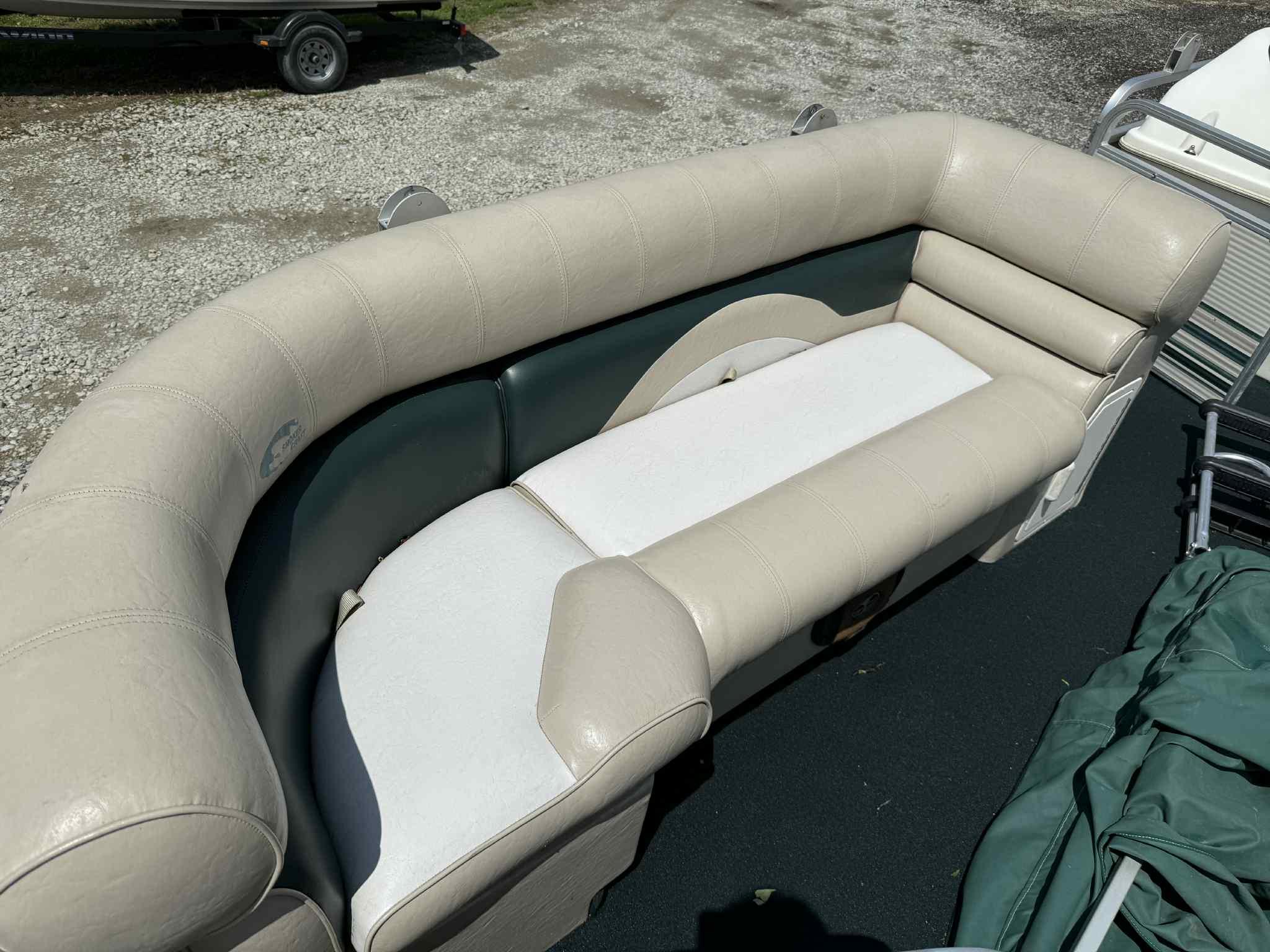 1999 Smoker Craft 8526 Pleasure Isle I/O boat seating, beige upholstery, outdoor setting.