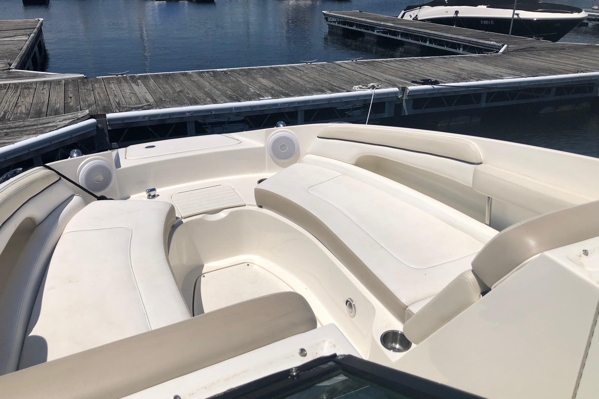 2013 Sea Ray 260 Sundeck boat interior with white seating at marina.