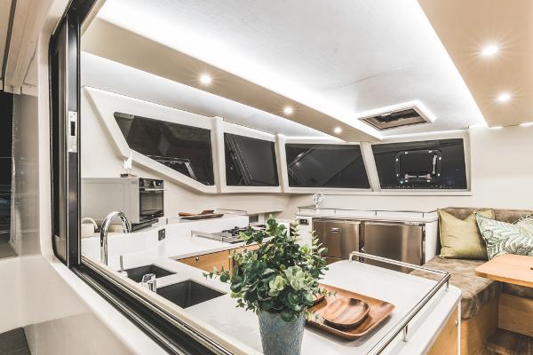 Luxurious Vision 444 yacht interior, featuring modern kitchen and seating area, 2025 model.