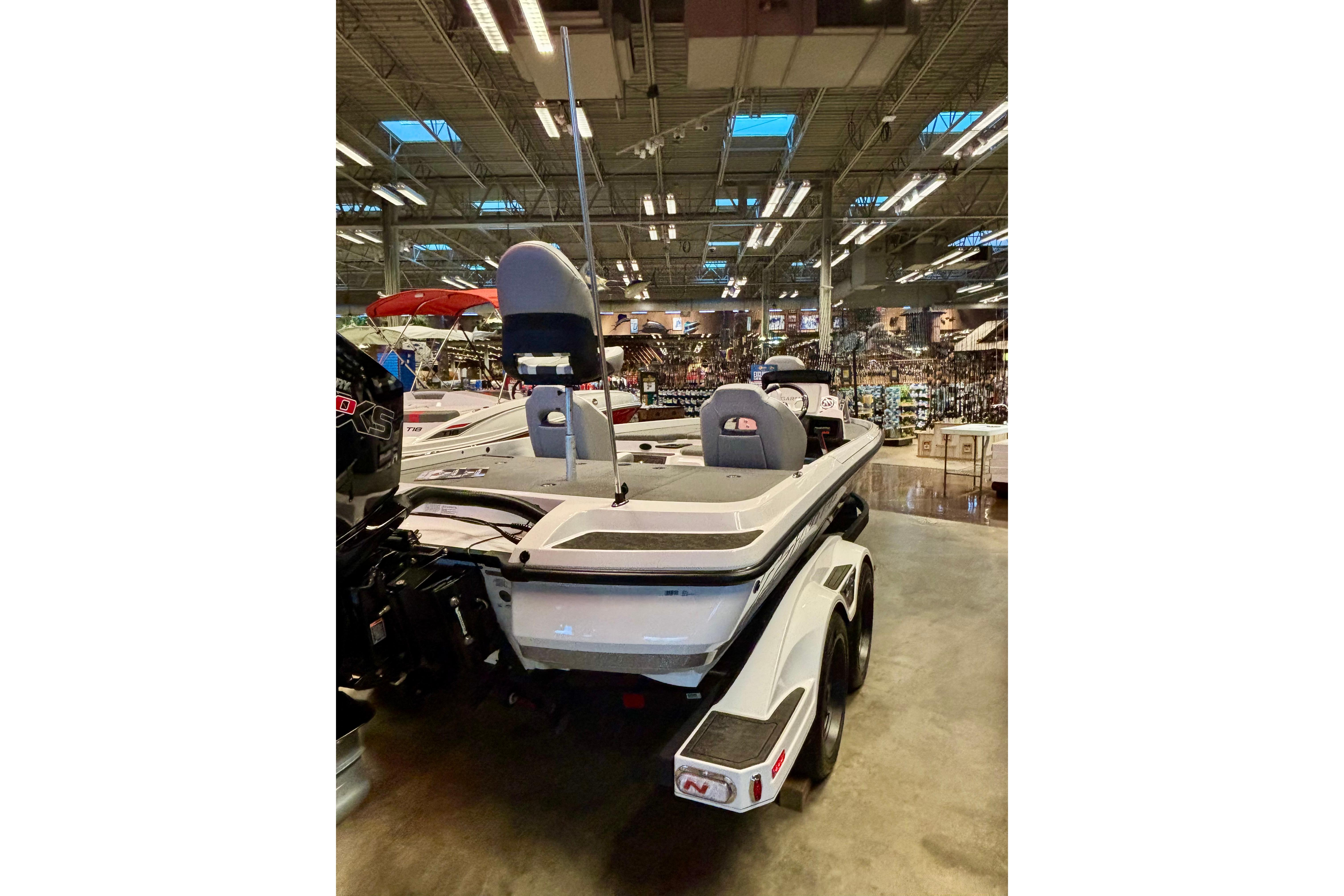 2026 Nitro Z21 XL Pro boat displayed in a showroom, rear view.