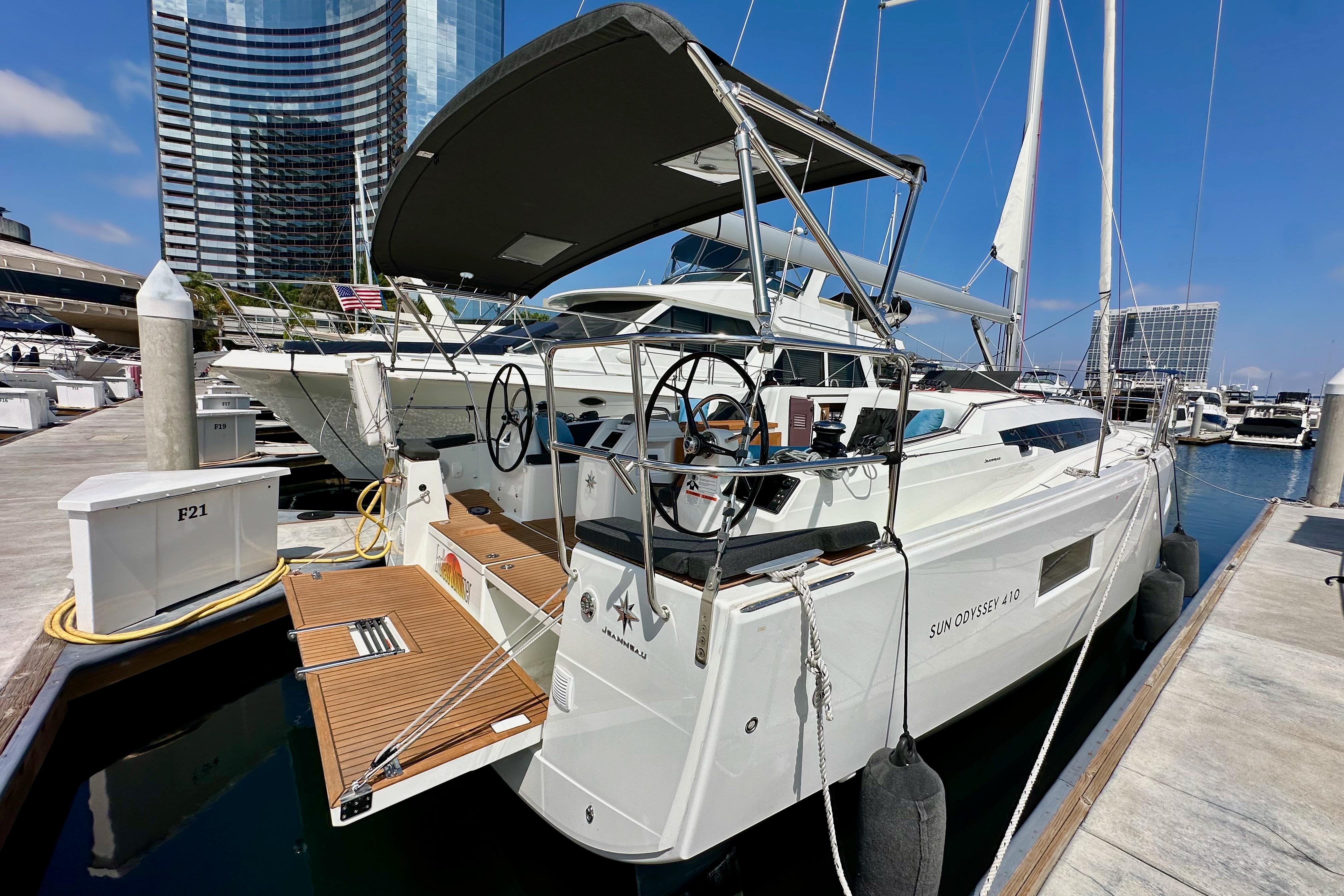 2024 Jeanneau Sun Odyssey 410 yacht docked at a marina, showcasing sleek design and modern features.