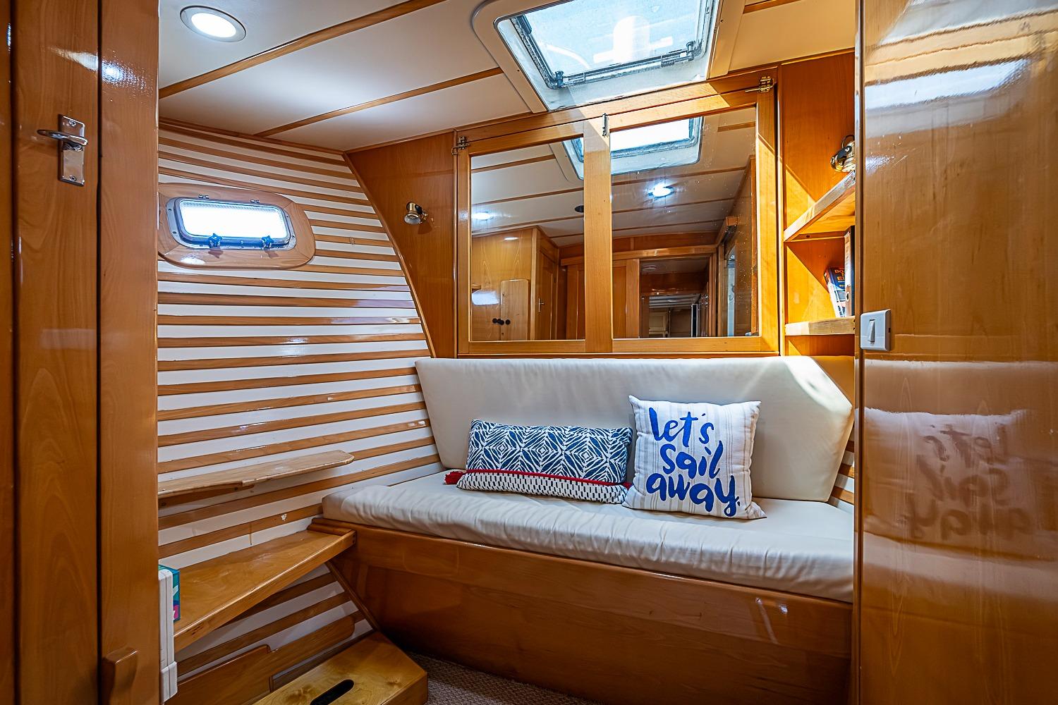 Cozy interior of 2003 Magna Marine Nova Scotia 47 yacht with striped walls and cushions.